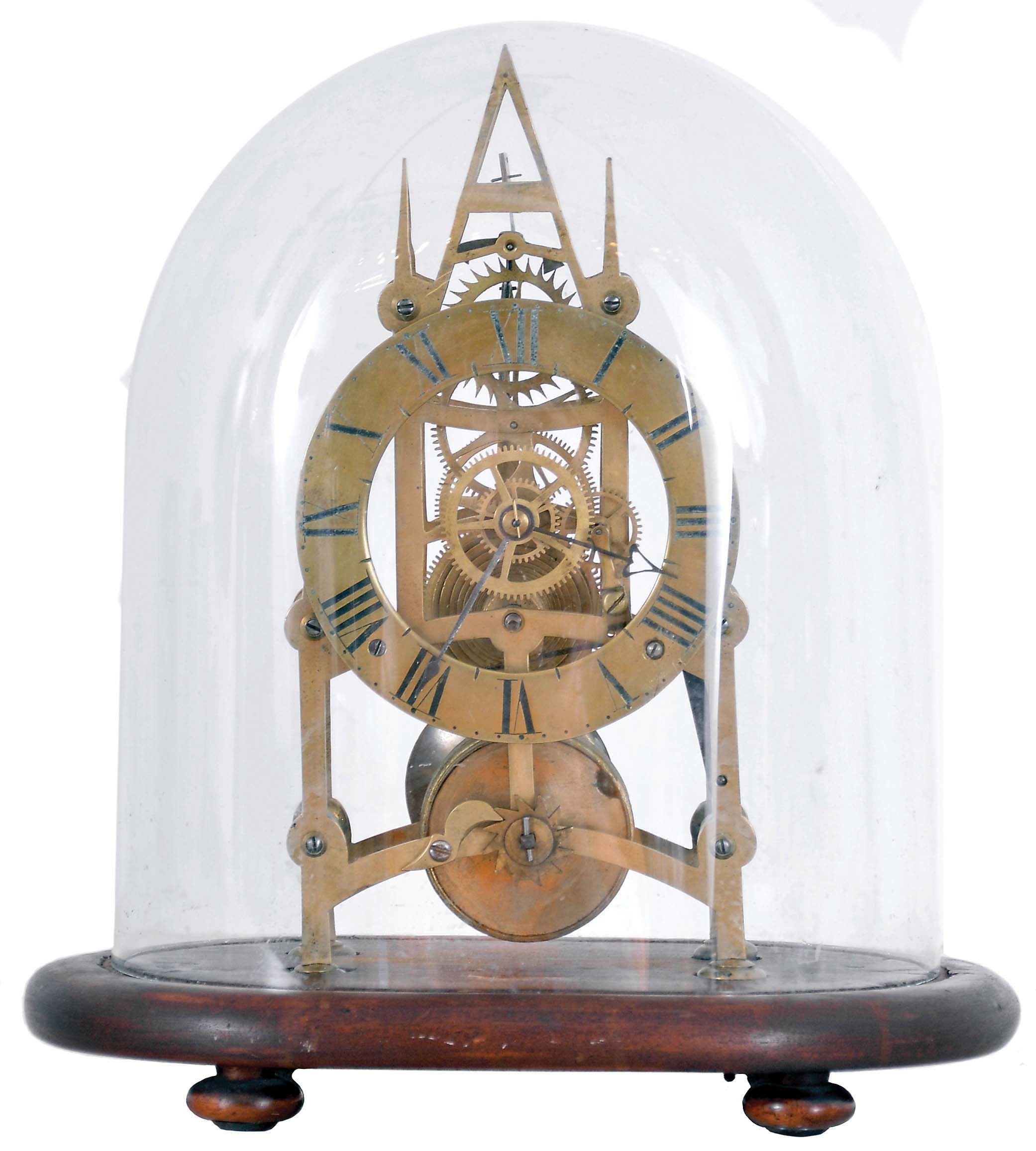 England, small Gothic skeleton clock, the pierced brass frame with 6 turned baluster form pillars, engraved Roman numeral brass dial, blued steel hands, and 8 day fusee timepiece movement, mounted to an oval mahogany base with glass dome. — Antique Clocks Price Guide
