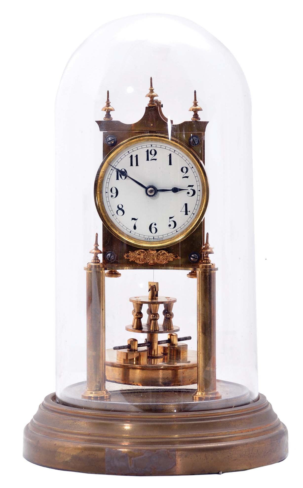 German 400-Day or Anniversary clock: (Retailer =Kuehl Clock Company, Chicago), time only spring driven movement torsion pendulum movement by Gustav Becker of Freiburg, Germany with disc pendulum in polished brass case under glass dome, c1910. — Antique Clocks Price Guide