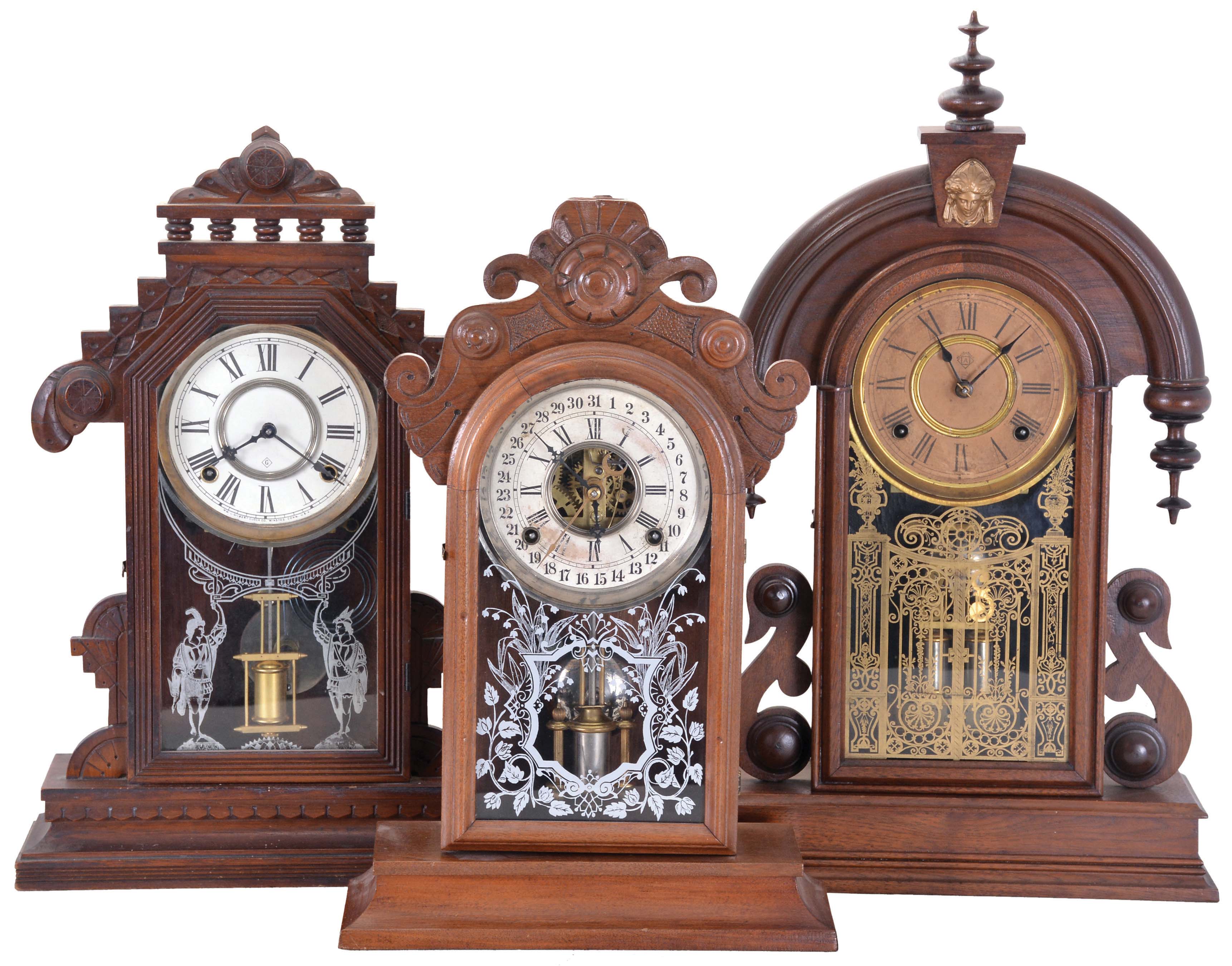 Clocks- 3 (Three): (1) William L. Gilbert Clock Co., Winsted, Conn., "Lebanon" shelf clock with a spring driven, 8 day, time and strike movement in a walnut case, c1885; (2) Ansonia Clock Co., New York, NY, "Parisian" shelf clock with a spring driven, 8 day time and half hour strike movement in a black walnut case, c1880; (3) William L. Gilbert Clock Co., Winsted, Conn., unidentified shelf model with a spring driven, 8 day, time and strike movement with a simple calendar mechanism in a walnut case, c1885. — Antique Clocks Price Guide