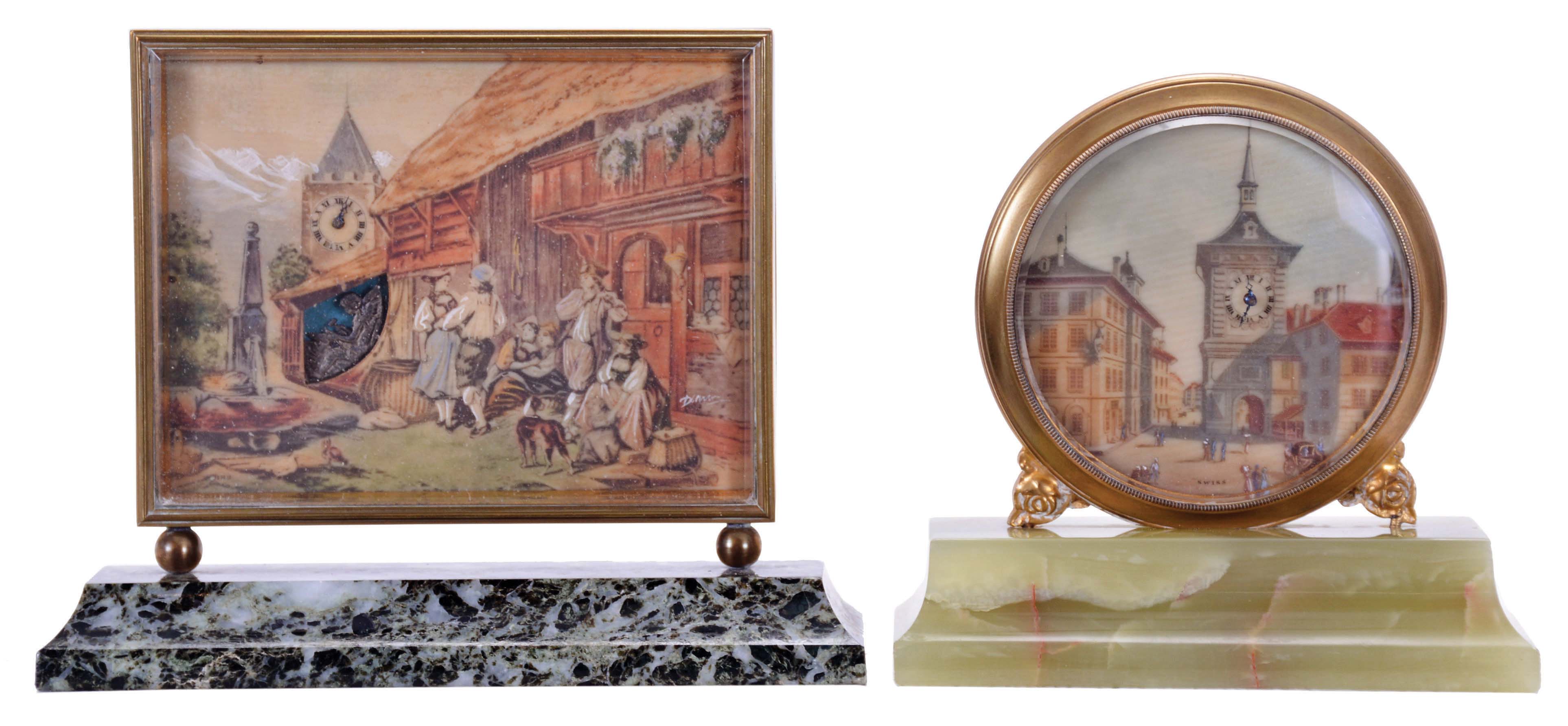 Didisheim, Goldschmidt, Fils & Co., Switzerland- 2 (Two) 30 hour desk timepieces: (1) the first marked "Idylle au Village" and features a European scene, and with an automated Cupid forging arrows below the clock tower, mounted to a green, variegated marble base, (2) the other with European streetscape, featuring buildings and a clock tower, and mounted to a green onyx base, dimensions of first clock listed — Antique Clocks Price Guide