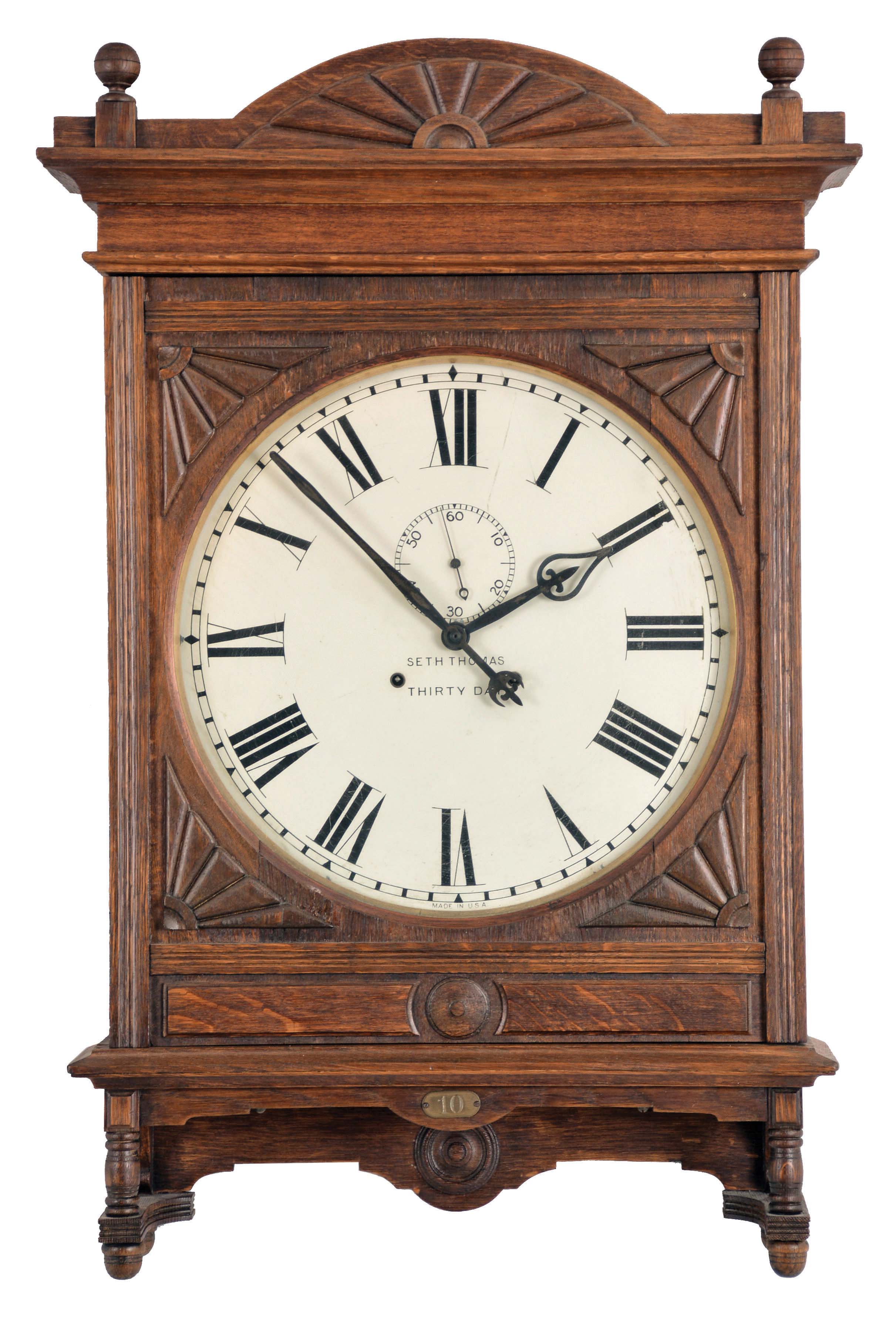 Seth Thomas Clock Co., Thomaston, Conn., "Lobby, 18 Inch" wall hanging clock with a spring driven 30 day timepiece movement in an oak case. — Antique Clocks Price Guide