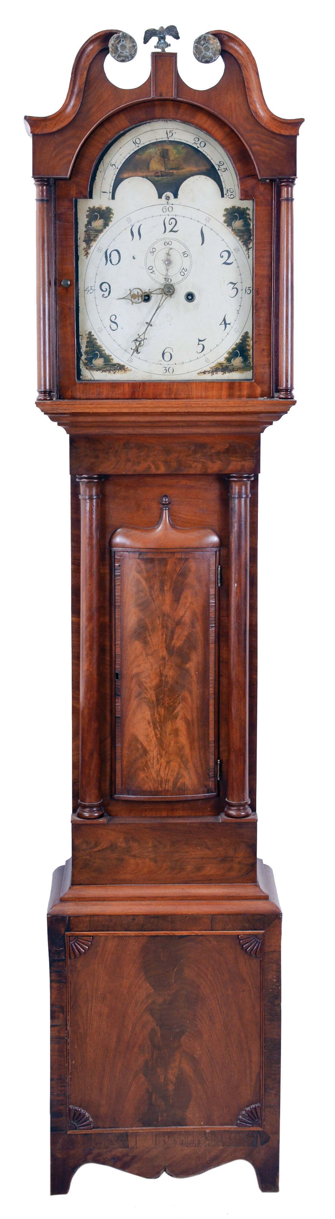 England, unsigned tall clock, 8 day, time and bell strike, weight driven movement, mahogany case with broken arch hood with brass rosettes, convex crotch mahogany panel 3/4 columns on trunk and fan carved crotch mahogany panel on lower plinth with painted metal dial with moon phase, swan spandrels. — Antique Clocks Price Guide