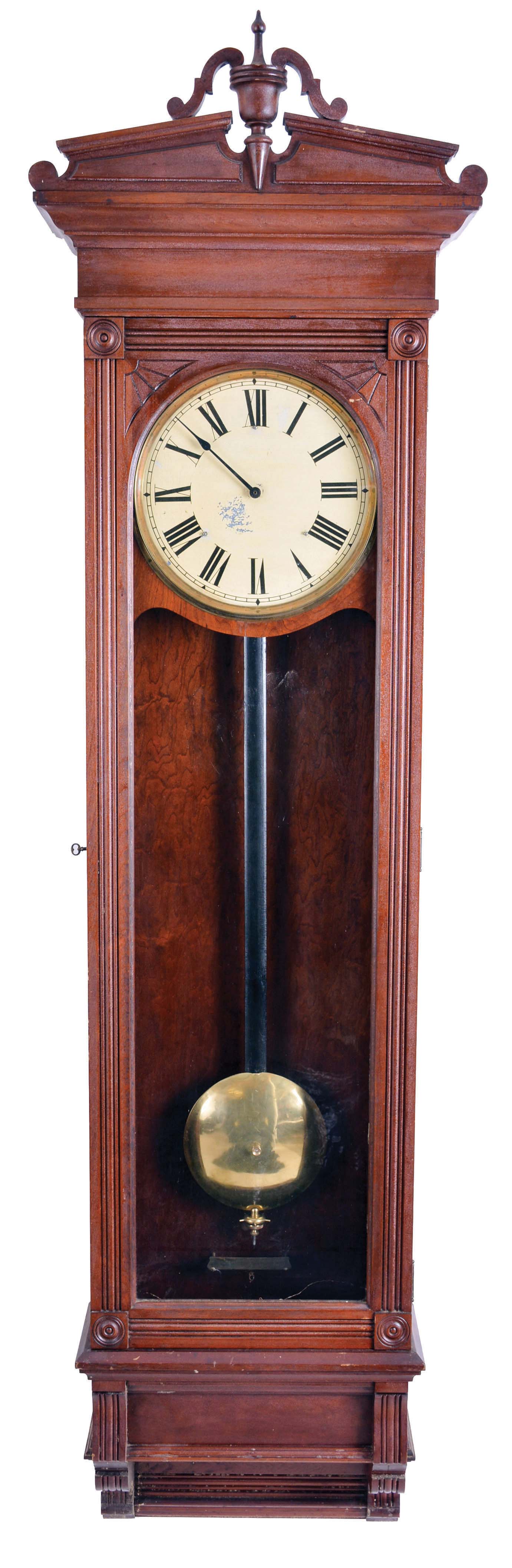 New York Standard Watch Co., Jersey City, New Jersey, electric hanging regulator, walnut case with molded door and base, Roman numeral painted dial with brass bezel, in line movement with Hipp toggle, pendulum with ebonized wooden rod and heavy brass clad ball — Antique Clocks Price Guide