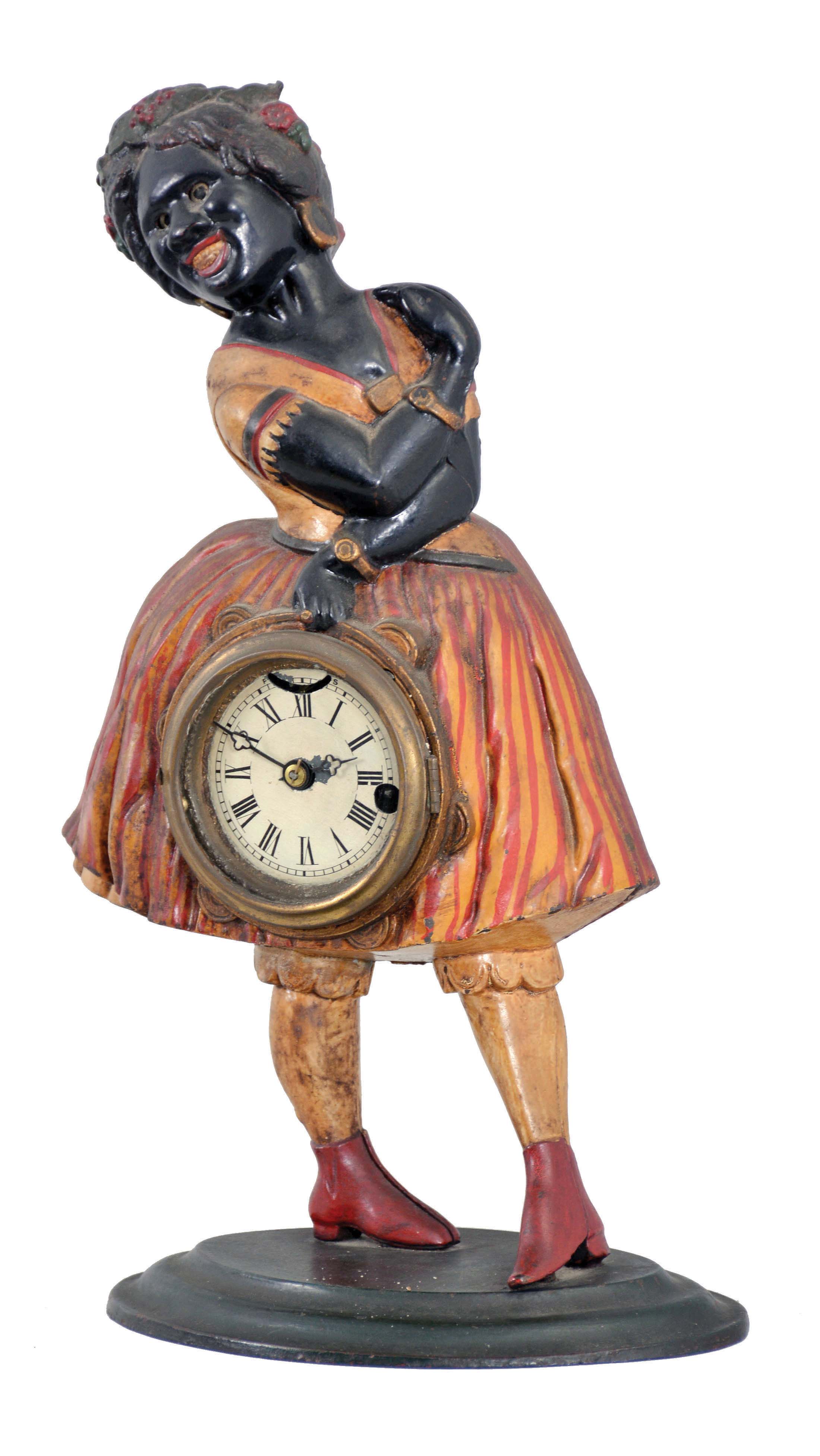 Bradley and Hubbard, Meriden, Conn., "Topsey" blinking eye clock with a spring driven balance wheel timepiece movement (unsigned) in a cast iron case. — Antique Clocks Price Guide