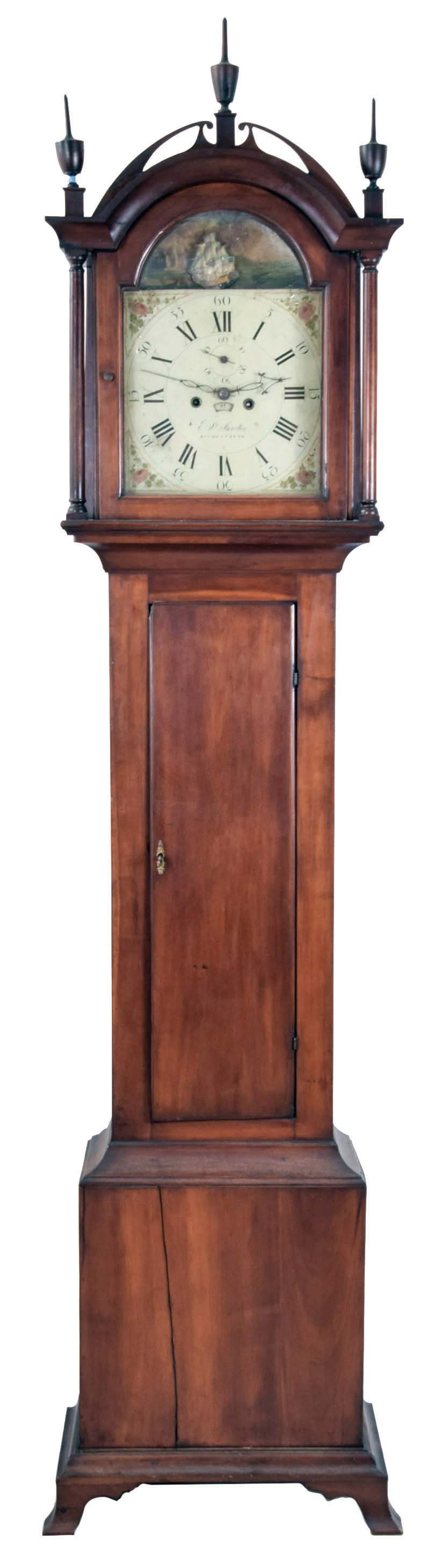 Edward S. Moulton, Rochester, New Hampshire tall case clock, the cherry case with fretwork top, turned finials and ogee bracket feet, numbered and signed by the maker, Roman numeral painted metal dial with seconds bit, calendar, and rocking ship, the back with label of Spencer & Nolen, Washington St., Boston, 8 day, time and strike, brass weight driven movement — Antique Clocks Price Guide