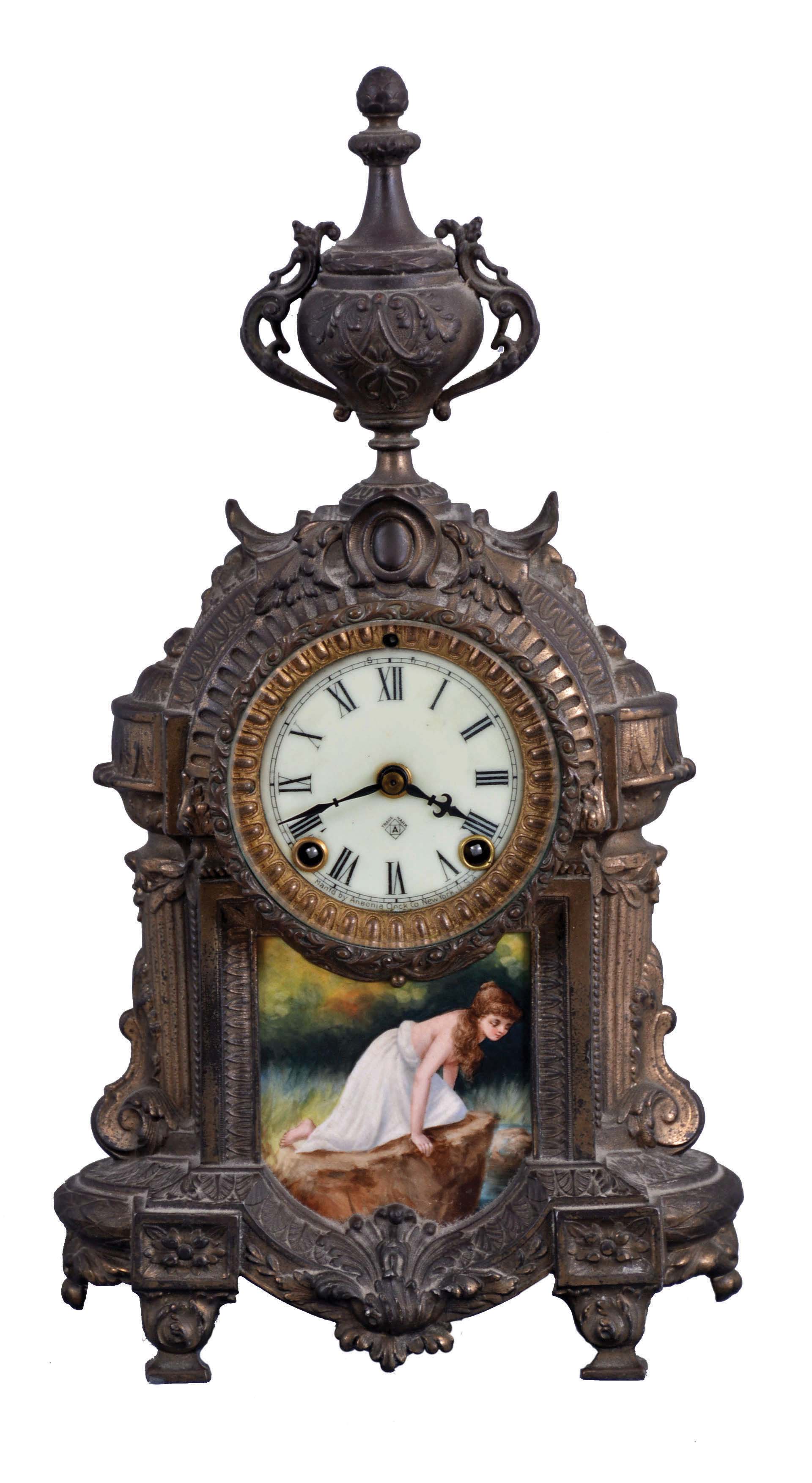 Clocks- 2 (Two): (1) Ansonia Clock Co., New York, NY, "Versailles" mantel clock with a spring driven, 8 day time and half hour strike movement in a cast metal case, c1914. ; (2) New Haven Clock Co., New Haven, Conn., "Winnipeg" hanging clock with a spring driven, 8 day timepiece movement in a walnut case, c1885. — Antique Clocks Price Guide
