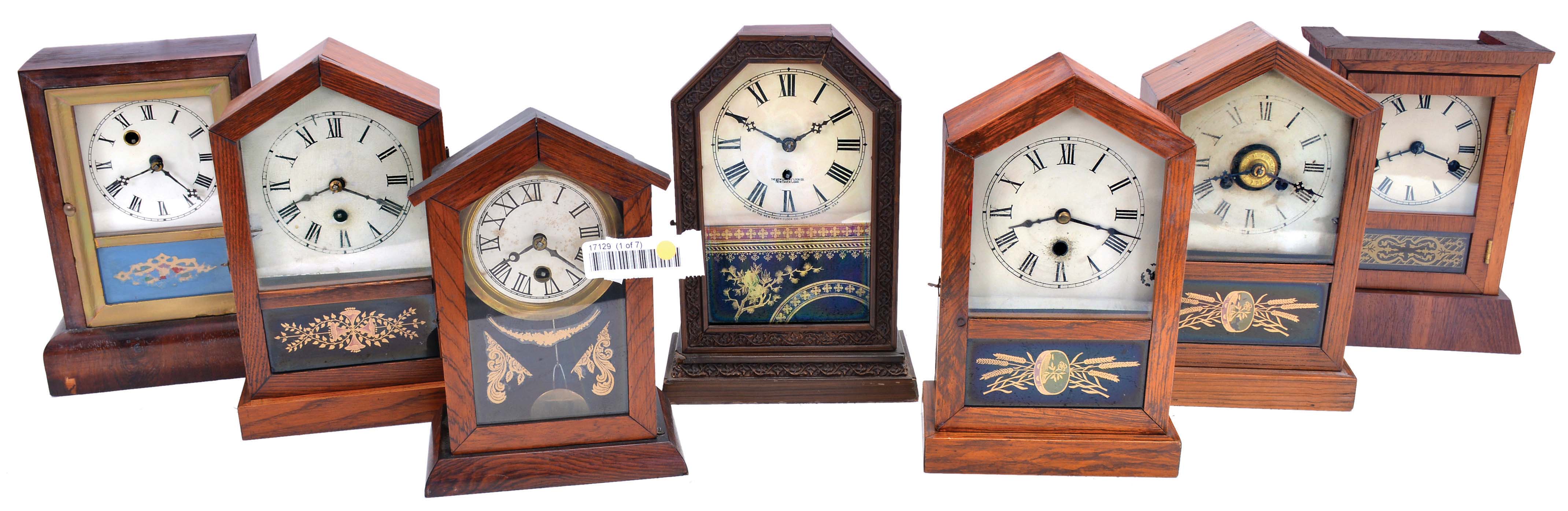 Clocks- 7 (Seven): (1) Waterbury Clock Co., Waterbury, Conn., Cottage shelf clock with a spring driven 30 hour timepiece movement in a rosewood veneered case, c1870; (2) Jerome & Co., New Haven, Conn., "Rocket" shelf clock with a spring driven 30 hour timepiece movement in an oak case, c1870; (3) Unidentified cottage shelf clock (likely German) with a spring driven 30 hour timepiece movement, c1870; (4) New Haven Clock Co., New Haven, Conn., cottage shelf clock with a spring driven 30 hour timepiece movement in a grained wood case, c1870; (5) Jerome & Co., New Haven, Conn., "Rocket" shelf clock - case only; (6) Jerome & Co., New Haven, Conn., "rocket" shelf clock with a spring driven 30 hour time and alarm movement in a grain painted case, c1870; (7) Seth Thomas Clock Co., Thomaston, Conn., "Anchor" shelf clock with a spring driven 30 hour time and strike movement in a rosewood veneered case, c1870. — Antique Clocks Price Guide