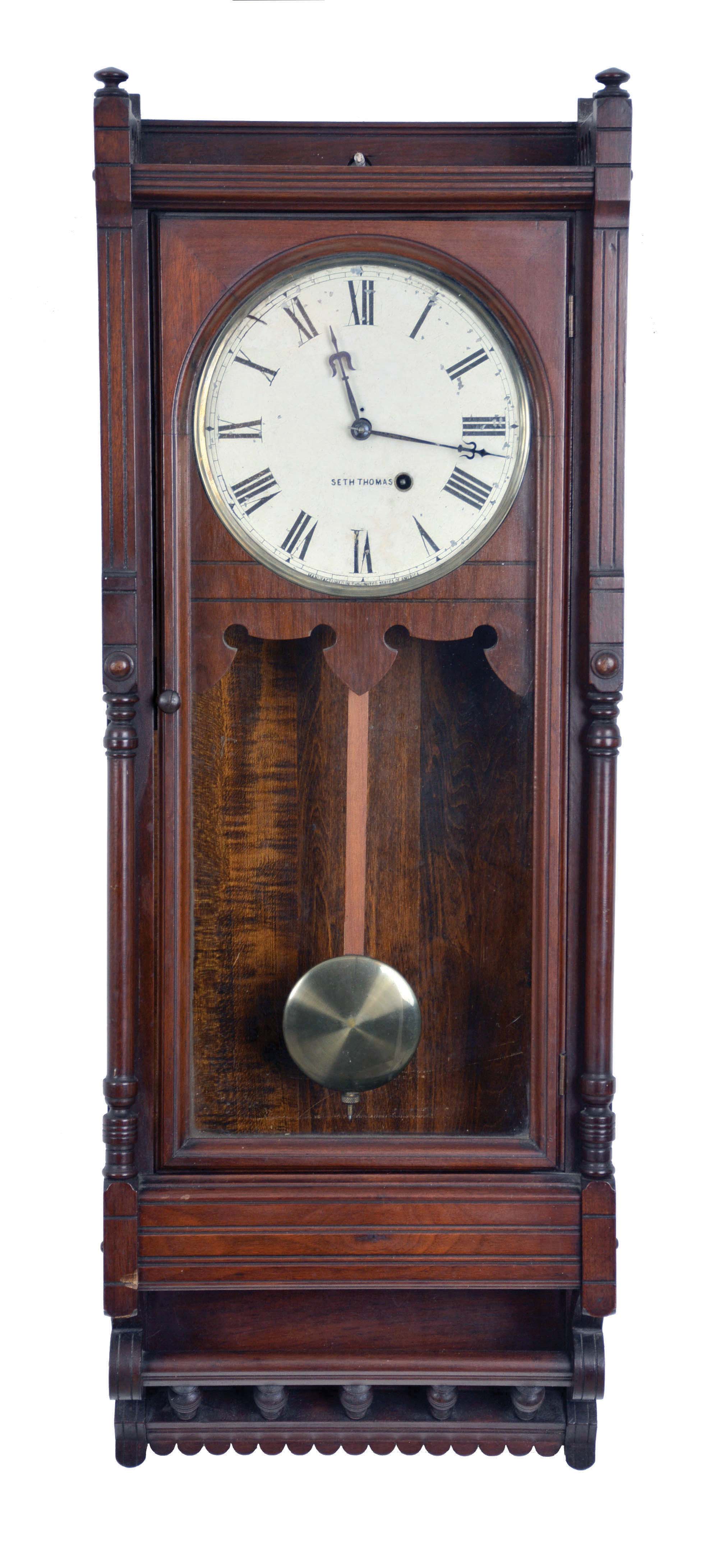 Seth Thomas Clock Co., Thomaston, Conn., "Queen Anne" hanging clock with a spring driven, 8 day timepiece movement in a walnut case. — Antique Clocks Price Guide