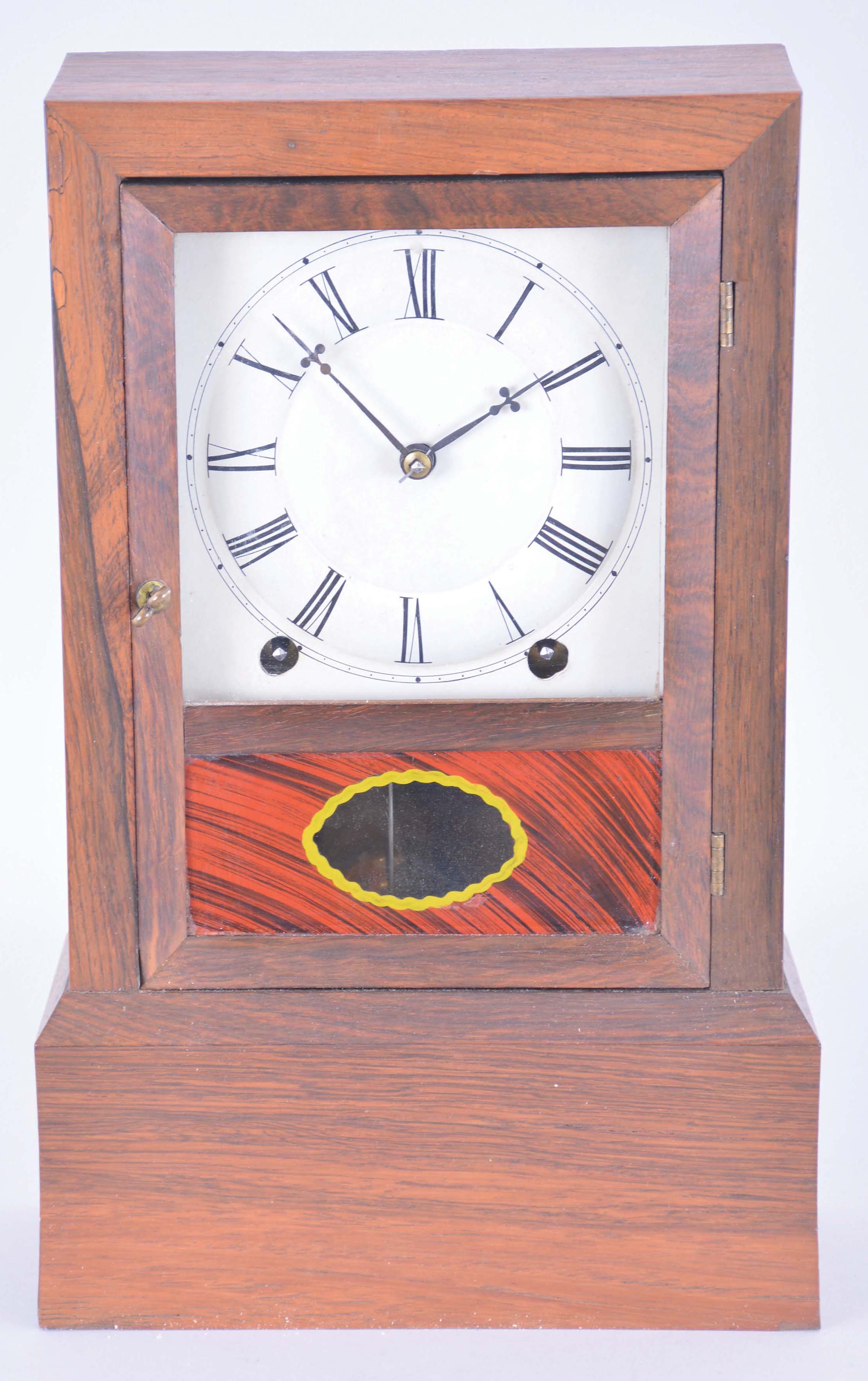 Clocks- 2 (Two): (1) American kitchen clock, time, strike and alarm weight driven movement with reverse painted tablet; (2) Bradley Manf'g. Co., Southington, Conn. cottage clock with a spring driven, 8 day, time and strike movement in a rosewood veneered case, c1855. — Antique Clocks Price Guide