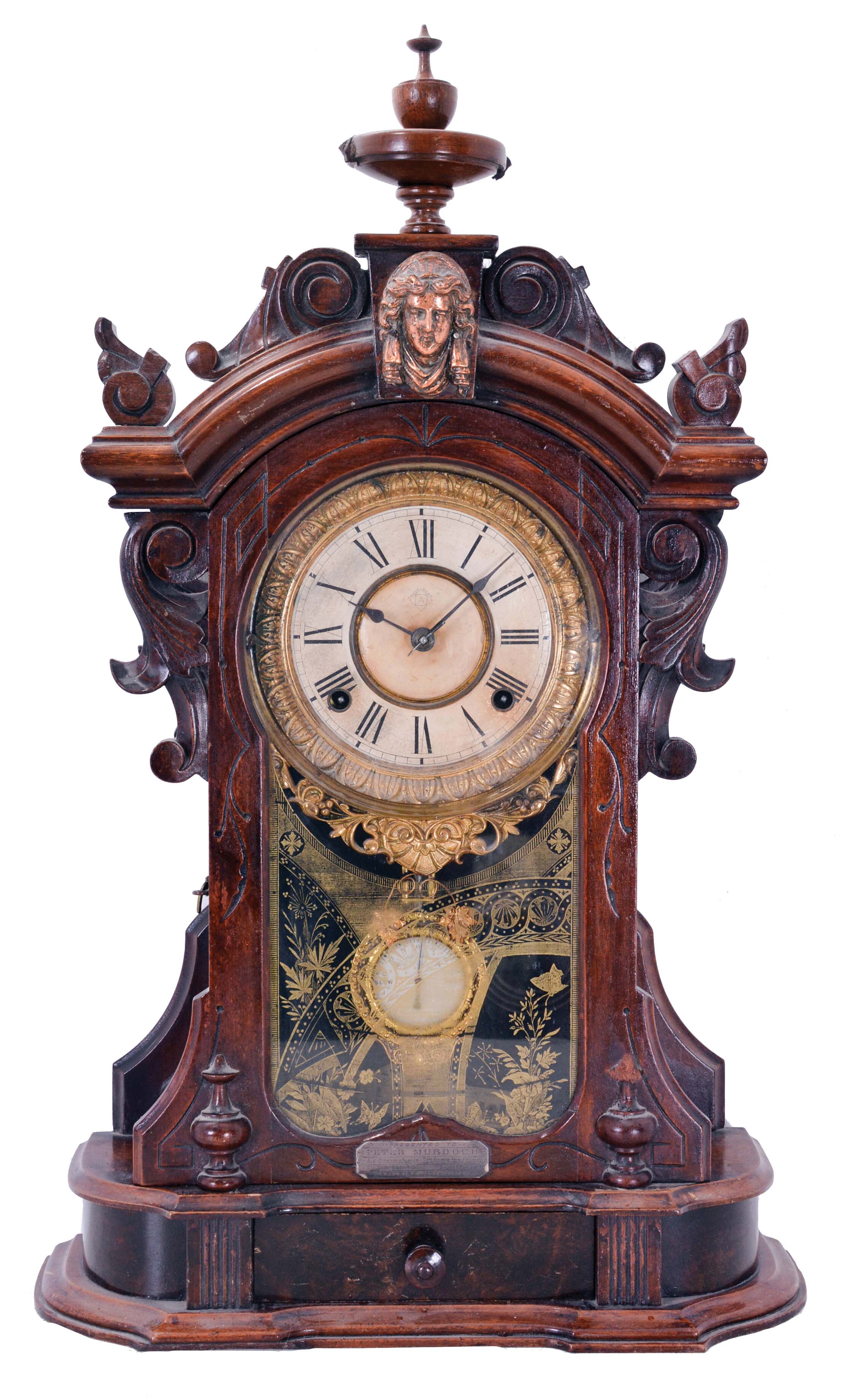 Ansonia Clock Co., New York, NY, "Monarch" mantel clock with 8 day, spring driven time and strike movement, in a walnut case with applied metal ornaments, patented pendulum, and dedication plaque dated 1892. — Antique Clocks Price Guide