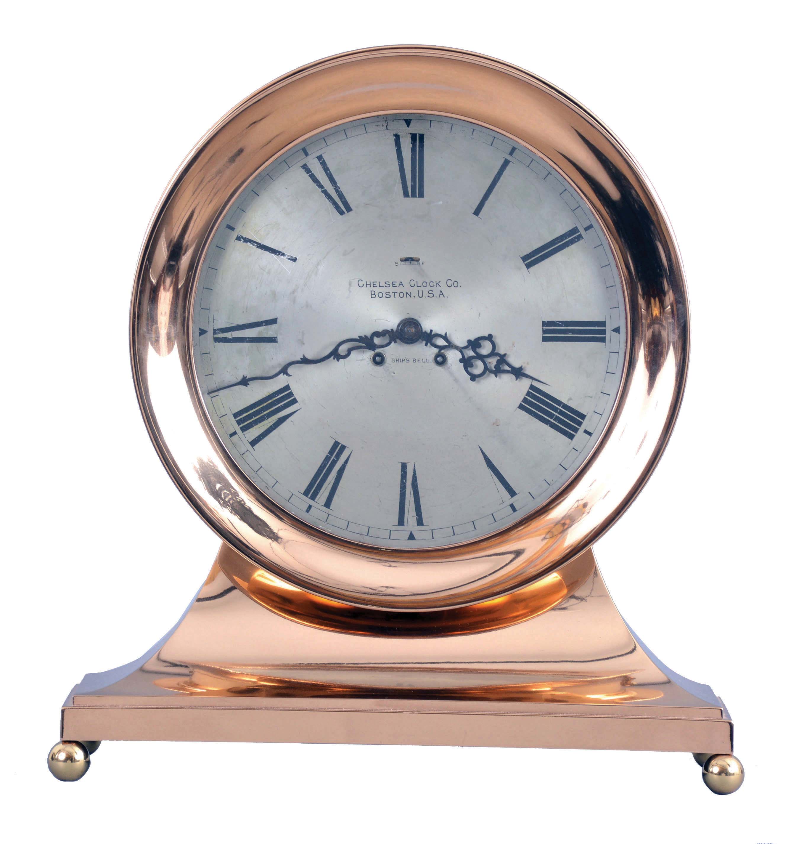 Chelsea Clock Co., Boston, Mass., retailed by Spaulding & Co., Chicago, "Commander" on metal base with 8 1/2" special dial, 8 day, spring driven, time and ship's bell striking movement in a polished brass case mantel clock — Antique Clocks Price Guide