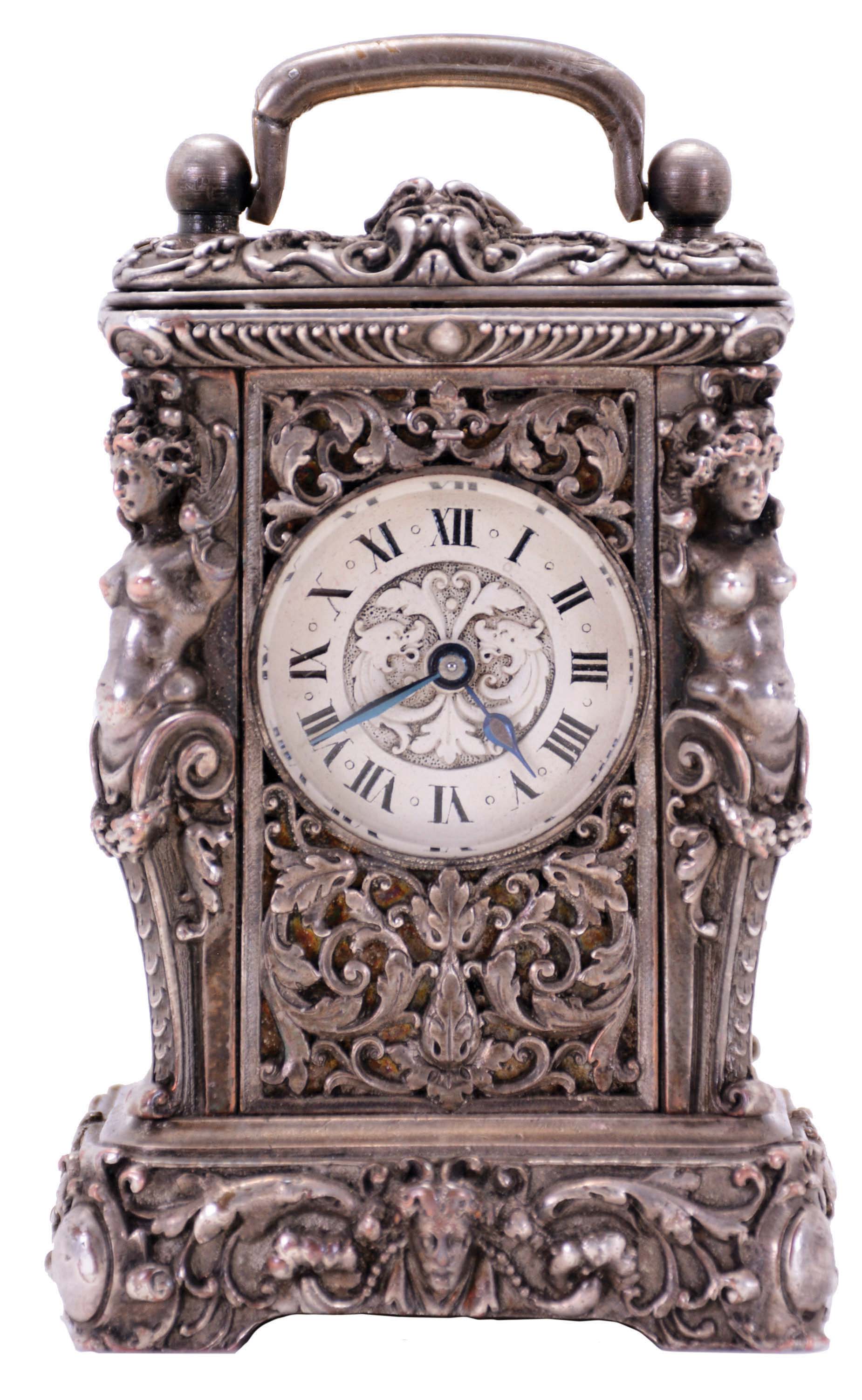Charles Oudin, Paris, miniature Caryatides style carriage clock, the silvered case with caryatid corners, masks and detailed foliate ornament, case top with handle, and beveled glass allowing observation of the oscillating balance, Roman numeral, dead white silvered dial, blued steel hands, 8 day timepiece movement with lever platform, the case bottom signed "Cles. Oudin 52 Palais Royal Paris" — Antique Clocks Price Guide