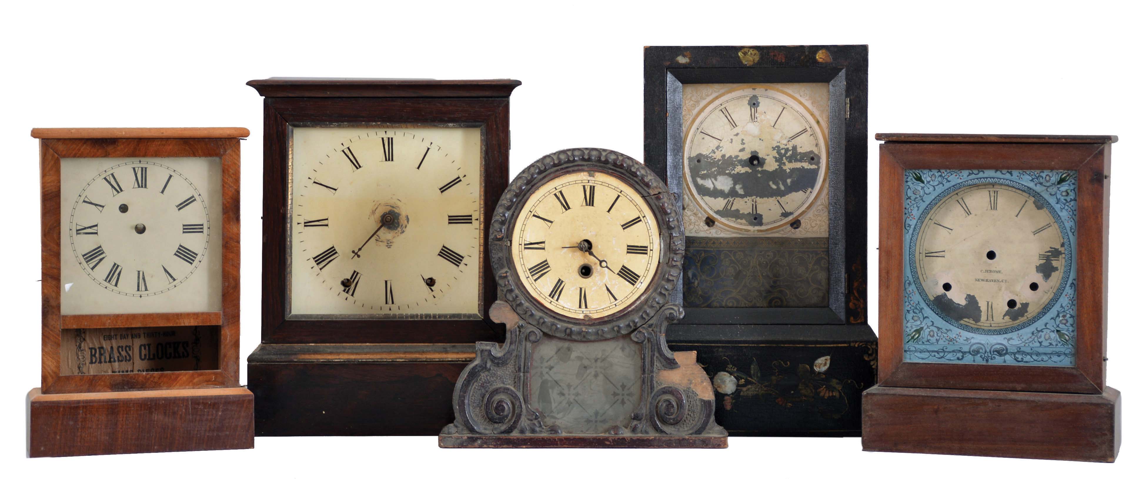 Clocks- 5 (Five): The first probably Chauncey Goodrich, ebonized, rectilinear case with mother of pearl, gilt and polychrome ornament, Roman numeral painted dial, 8 day, time and strike movement, the next probably by Jerome, rosewood veneered case with gold moldings, Roman numeral painted dial, 8 day, time and strike movement, the third a Waterbury cottage, softwood case with mahogany veneered front, Roman numeral painted dial, 30 hour timepiece movement, the next a Jerome cottage case and dial, door glass with decorative painted dial surround, and an unidentified 30 hour timepiece with applied composition ornament, dimensions of Goodrich listed — Antique Clocks Price Guide