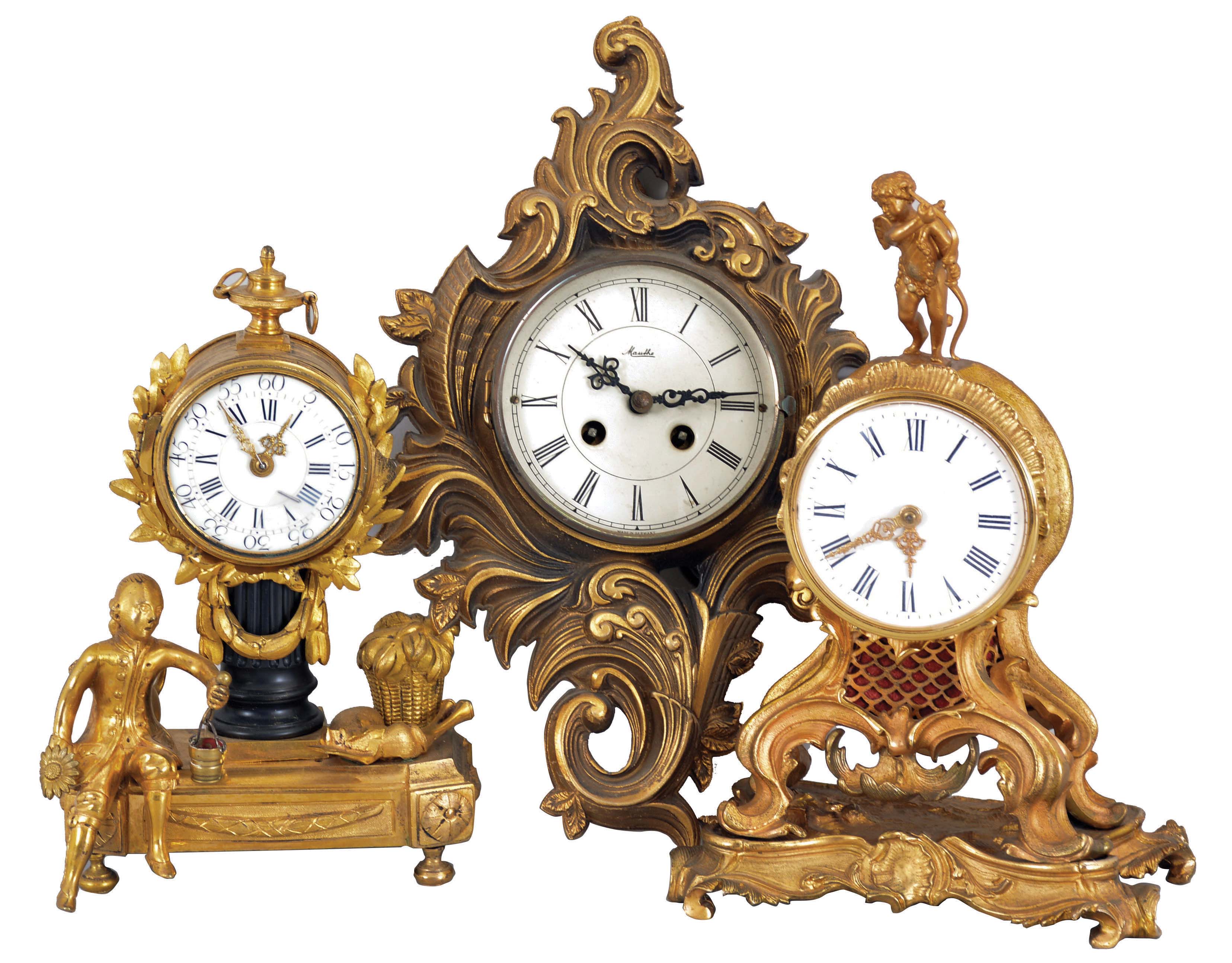 Clocks- 3 (Three) Gilt European: (1) France, figural mantel clock, 8 day time only balance wheel movement in a gilt cast brass and spelter case depicting a man with gardening implements and bagpipes with a white porcelain dial surrounded by laurels. (2) Mauthe Clock Company, Germany, miniature cartel clock, 8 day time and bim-bam bell strike in a gilt brass cartouche case. (3) France, mantel clock, 8 day time only balance wheel movement in a gilt cast brass and spelter case topped by Cupid with his bow with a white porcelain dial with Roman numerals. — Antique Clocks Price Guide
