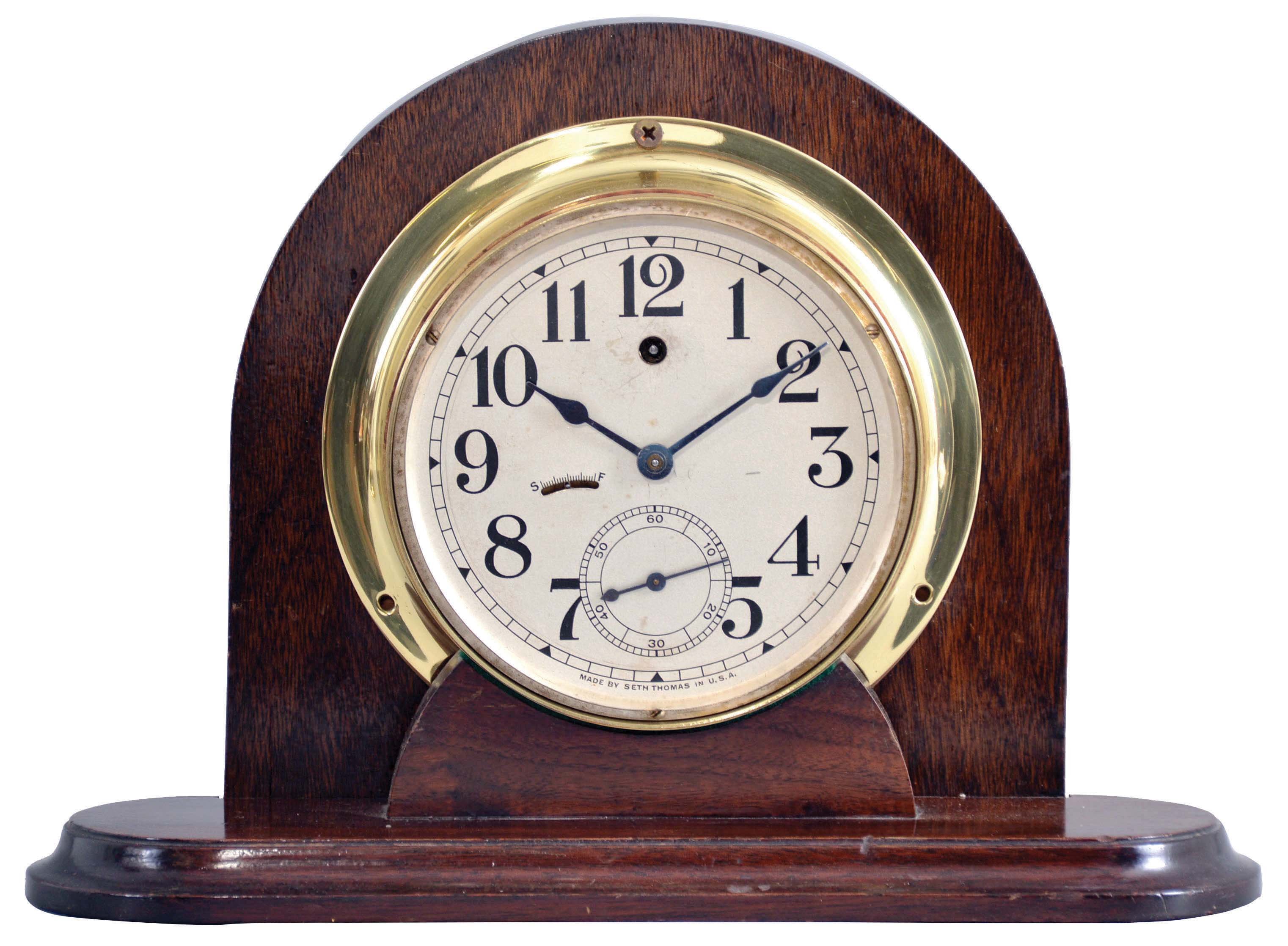 Seth Thomas Clock Co., Thomaston, Conn., "Ships Lever" pilot house clock, cast brass case with mounting flange and screw on bezel, Arabic numeral silvered dial with large seconds at 6:00, blued steel hands, 8 day timepiece movement with steel pinions and lever escapement, now mounted to a purpose made stand — Antique Clocks Price Guide