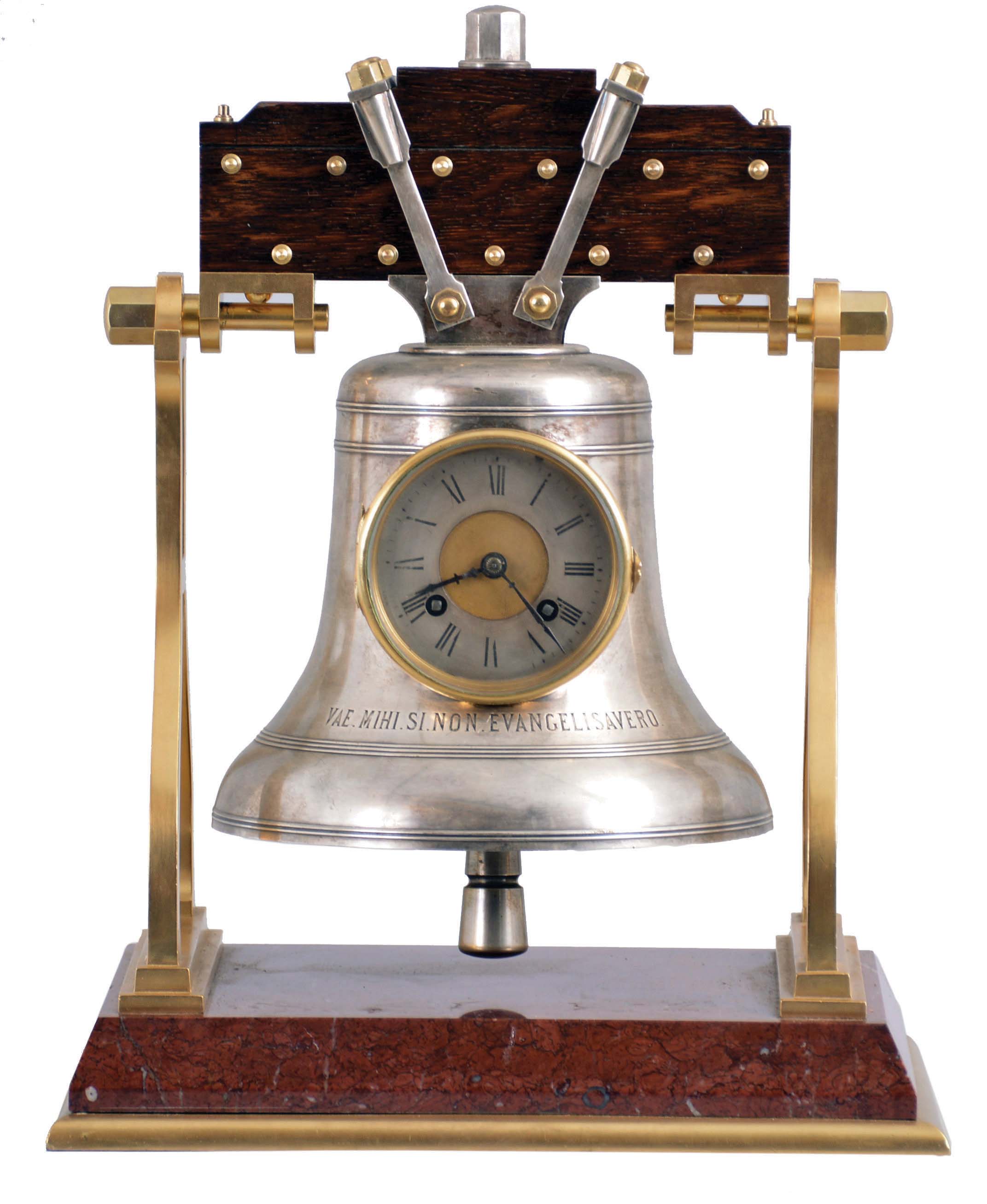 France, industrial series "Church Bell", gilt trimmed griotte marble base below stylized A shaped frames supporting the silver bell with oak headstock, all hardware in silvered or gilt finish, the bell front engraved "VAE. MIHI. SI. NON. EVANGELISAVERO" below the Roman numeral silvered dial, blued steel hands, 8 day, time and strike movement with lever platform — Antique Clocks Price Guide
