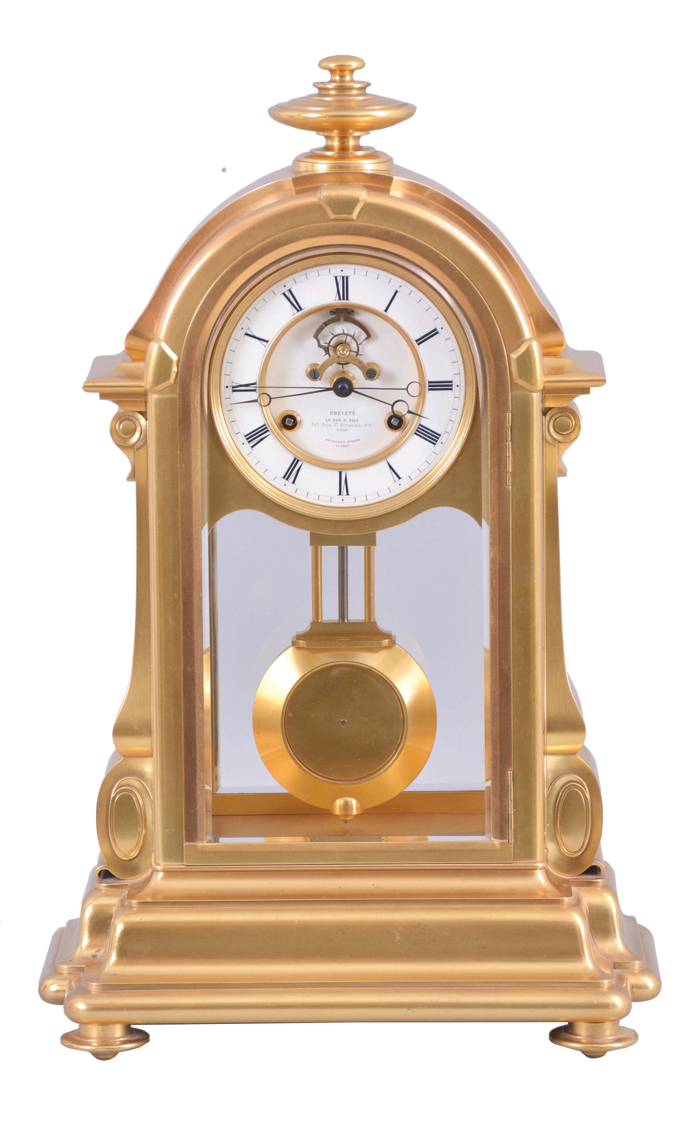 LeRoy & Fils, Paris, for the English market, a large and unusual mantel or table regulator with coup perdu escapement and center seconds, in a glazed, gilt bronze case with arch top, the base with bold torus, ogee, and cavetto moldings, the sides with inverted, scrolled consoles below cavetto and ogee molded trim, and the top with turned finial, Roman numeral white enamel dial with recessed center, and visible escapement with jeweled pallets signed "Augte. Pointeaux", blued steel Breguet style hands, 8 day, time and strike movement by Pons with square plates, and with knob for setting at the upper left side of the back plate, gilt pendulum with heavy brass ball, dial and movement signed. — Antique Clocks Price Guide