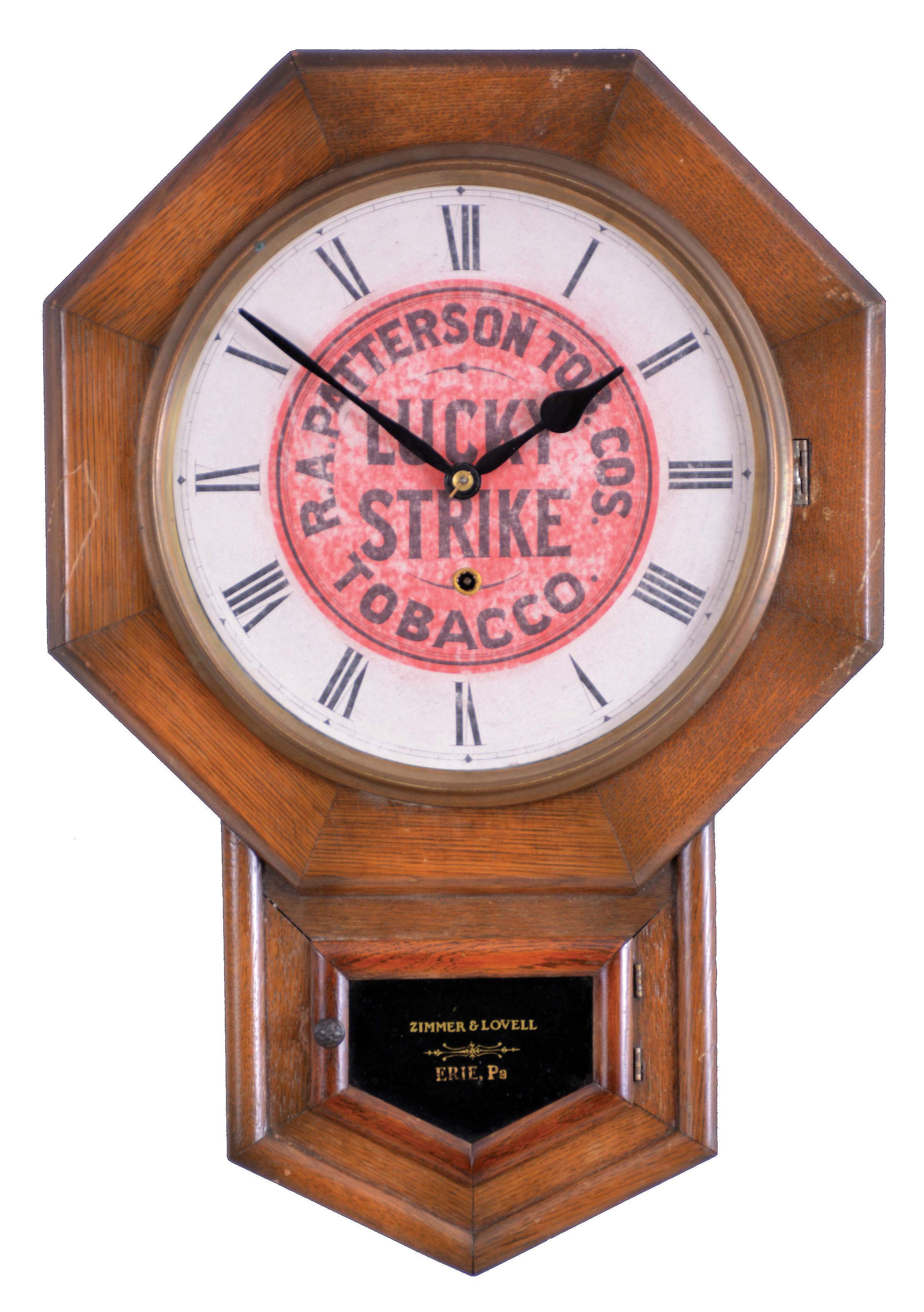 New Haven Clock Co., New Haven, Conn., "Drop Octagon" wall clock with Lucky Strike advertising, 8 day, time only, spring driven movement in an oak case with a tablet stenciled with retailer "Zimmer & Lovell, Eerie, Pa" — Antique Clocks Price Guide