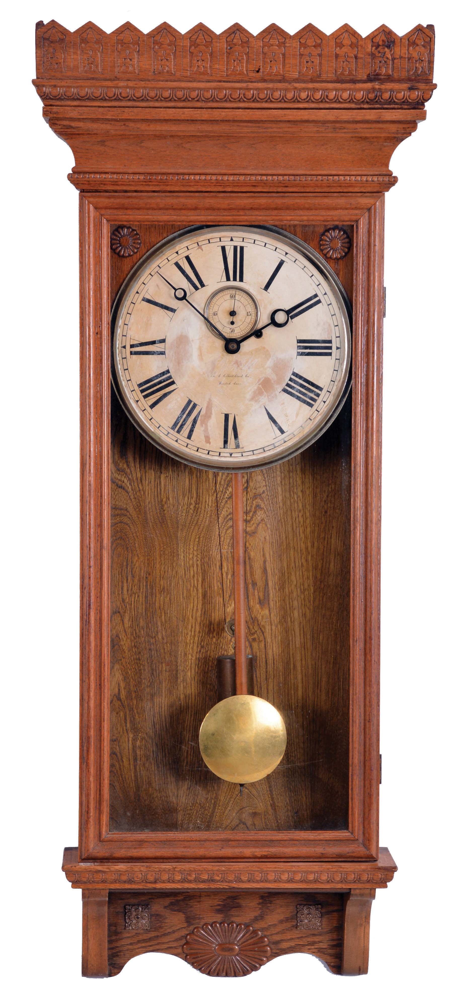 William L. Gilbert Clock Co., Winsted, Conn., "Regulator No. 14" hanging clock with a weight driven 8 day timepiece movement with dead beat escapement and retaining power, in an oak case. — Antique Clocks Price Guide
