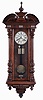 Germany, a large 2-weight "Vienna Regulator", walnut case with turned and carved ornament, turned finial and drops, two piece Roman numeral enamel dial signed "J. Wilde, Monmouth, blued steel hands, 8 day time and strike, weight driven movement, brass pendulum with wooden rod, brass weights