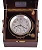 Hamilton Watch Co., Lancaster, Penn., model 21 marine chronometer, 14 jewel key wind and set, straight line damascened nickel plate movement with spring detent escapement and chronometer balance with helical hairspring, Arabic numeral metal dial with wind indicator, black painted steel spade and poker hands, contained in a gimbaled mahogany box with brass hardware, serial #2E2204, "N2204" marked on dial indicating that it was commissioned for use on a Navy vessel
