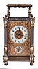 France, carriage clock with alarm, brass case with columns at the corners, turned feet and finials, and blind fret trim at top and base, Arabic numeral white enamel dial with gilt, filigree mask, 8 day time and alarm movement with lever platform, with leather covered outer case