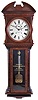 E. Howard & Co., Boston, Mass., "Regulator No. 57", jeweler's regulator wall clock, the walnut and burl walnut case with bold quarter columns, having turned and carved capitals and turned bases, flanking the burl veneer trunk door with reverse painted and gilt presentation, "THE GREEN SHOE MFG. CO. (INC.) NOV. 24, 1924. BY THE EMPLOYEES", over a burl veneered, stepped, tapered bottom bracket, upper door with raised wooden spandrels enframing the dial, over a nicely detailed carved molding above trunk door, and fan carved, broken arch top, Roman numeral painted dial signed "E. HOWARD & CO. BOSTON", 8 day, time only, weight driven movement with maintaining power and large brass, decorated bob and gold leafed pendulum rod, with cylindrical weight.