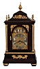 Walker, London, a large, three train bracket clock chiming on eight bells, mahogany case with faux rosewood finish and turned, gilt gadroon mounted feet, the base with gilt, floral festoons, door with gilt mounts, front corners with flanking, reeded columns supporting the molded cornice and caddy top, also with gilt foliate ornament, and pineapple finial, case sides with cast, pierced frets decorated with rococo motifs and central masks, composite dial with matted center, Roman numeral, silvered chapter ring below subsidiary chime selection dials, pierced, blued steel hands, and substantial, three train fusee movement