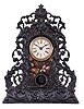 American Clock Co., New York, attribution fancy cast iron front mantel clock with an 8 day spring driven time and strike movement (marked S. Thomas, Plymouth, Conn.) .