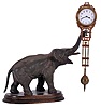 Junghans, Germany, elephant model swinging clock, patinated figure of an elephant mounted to a molded beechwood base, the 8 day swinging timepiece held aloft at the end of his trunk, clock case with gilt and patinated surfaces, Arabic numeral white enamel dial signed "Junghans Germany" below 6:00, blued steel hands, 8 day time only movement