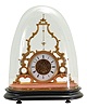 France, skeleton clock with conical pendulum, the triangular, openwork gilt frame ornamented with c scrolls and foliage, Roman numeral white enamel dial, blued steel Breguet style hands, 8 day timepiece movement, the back plate marked "Medaille de Bronze" beneath an eagle, gilt pendulum with silver plated ball, all resting on a velvet lined, ebonized wooden base, and covered with a glass dome