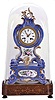 France, a two part, rococo style porcelain mantel clock with case in the style of Jacob Petit, the clock and stand both decorated with molded and brightly painted naturalistic ornament, blue ground highlighted by bright gilding, all resting on an inlaid rosewood base with dome, Roman numeral white enamel dial, unusual, fancy gilt trefoil hands, 8 day, time and strike, pendule de Paris movement with silk thread suspension, the back plate marked "Medaille d'or Japy"