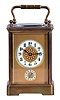 France, for Shreve, Crump & Low, Boston, striking carriage clock with alarm, brass Corniche case with beveled glasses, Arabic numeral white enamel dial with gilt mask, and subsidiary alarm chapter, blued steel distaff style hands, 8 day striking movement with lever platform, sounding the hour and half hour in passing