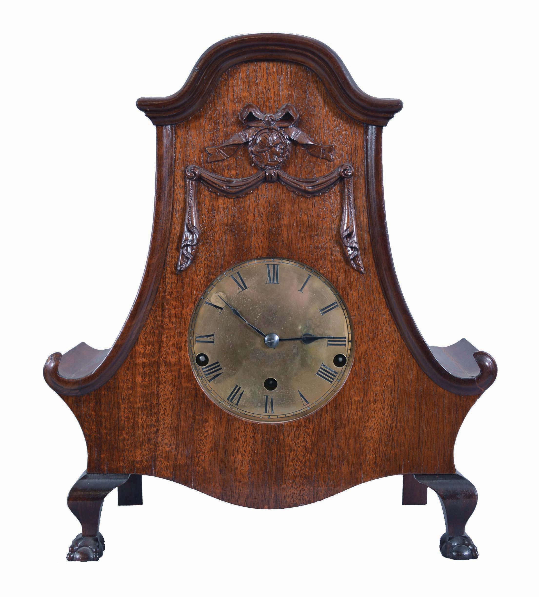 Clocks- 2 (Two) Wood and Brass: (1) Reproduction Clepsydra or water clock with cast brass crest and chapter ring, distressed wood pillars, woodworm holes in base, and rustic metalwork. The single hand is meant to move as water drips slowly from the cylindrical tank into the collection basin below; (2) Uhrenfabrik M,hlheim M,ller & Co., Germany, mantel clock, 8 day, three-train Westminster chime, spring driven movement stamped with the lion and "U.M." trademark in a curved mahogany case with ball-and-claw front feet and brass dial. — Antique Clocks Price Guide