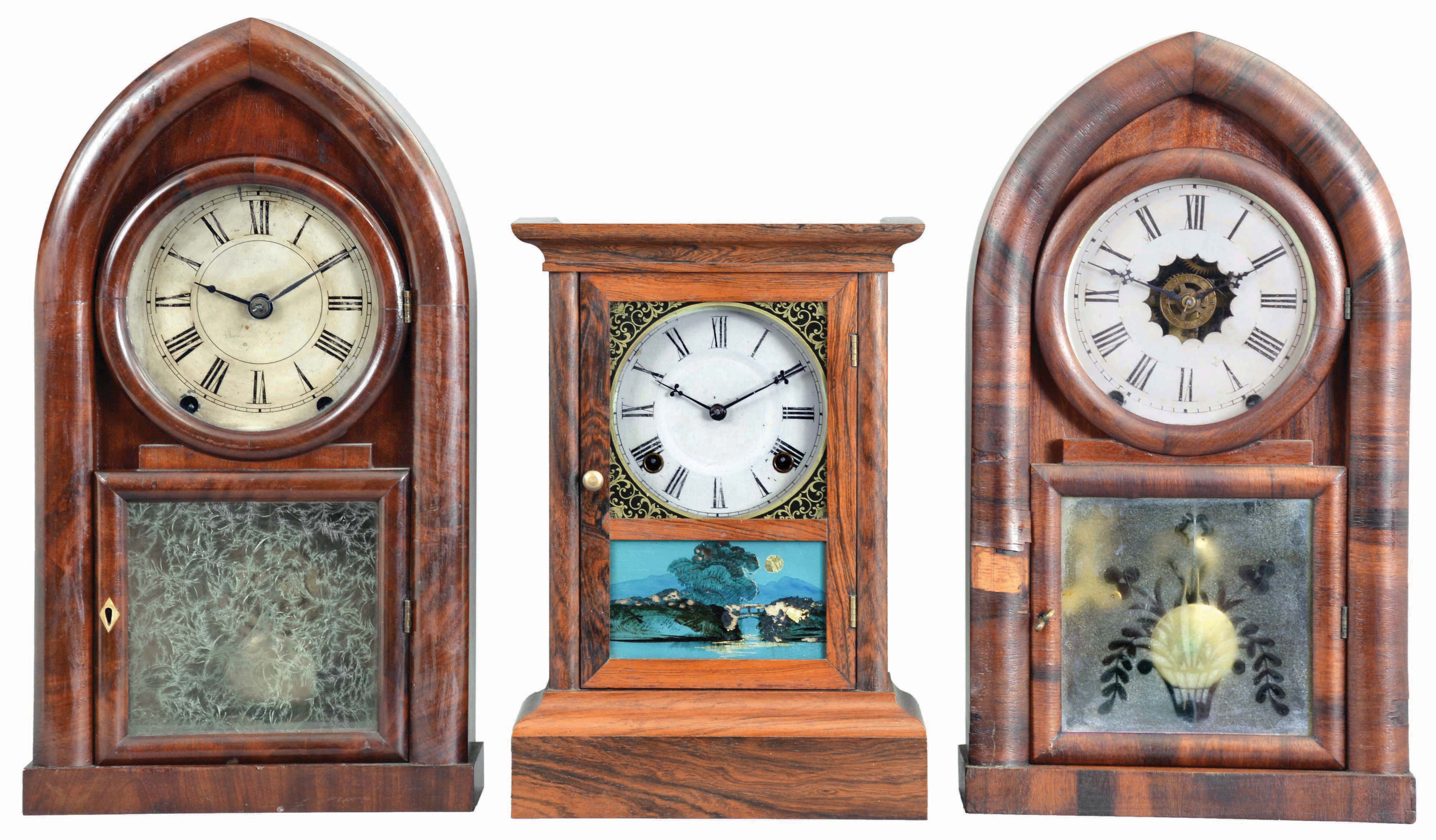 Clocks- 3 (Three): (1) Atkins Clock Co., Bristol, Conn., "Cottage XX" shelf clock with a spring driven, 8 day, time and strike movement in a rosewood veneered case, c1860; (2) Brewster & Ingrahams, Bristol, Conn., "Round Gothic" or "Beehive" shelf clock with a spring (brass) driven, 8 day, time and strike movement in a mahogany veneered case, c1848. (3) William L. Gilbert, Winchester, Conn., "Beehive" shelf clock with a spring driven, 8 day time, strike and alarm movement in a rosewood veneered case, c1850. — Antique Clocks Price Guide