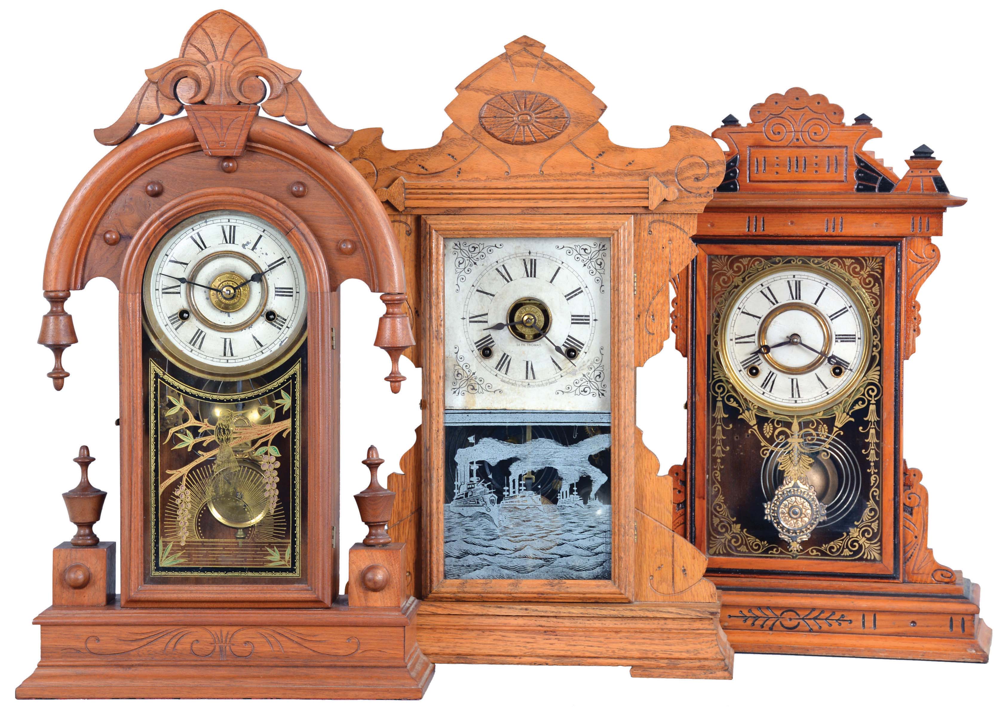 Clocks- 3 (Three): (1) Seth Thomas Clock Co., Thomaston, Conn., "Fleet Series" shelf clock with a spring driven, 8 day time, strike and alarm movement in an oak case, c1909; (2) E. N. Welch Mfg. Co., Forestville, Conn., "Coghlan" shelf clock with a spring driven, 8 day, time and strike movement in an ash case with ebonized accent, c1885. (3) New Haven Clock Co., New Haven, Conn., "Elbe" shelf clock with a spring driven, 8 day time, strike and alarm movement with a patent dial pendulum in a walnut case, c1880. — Antique Clocks Price Guide