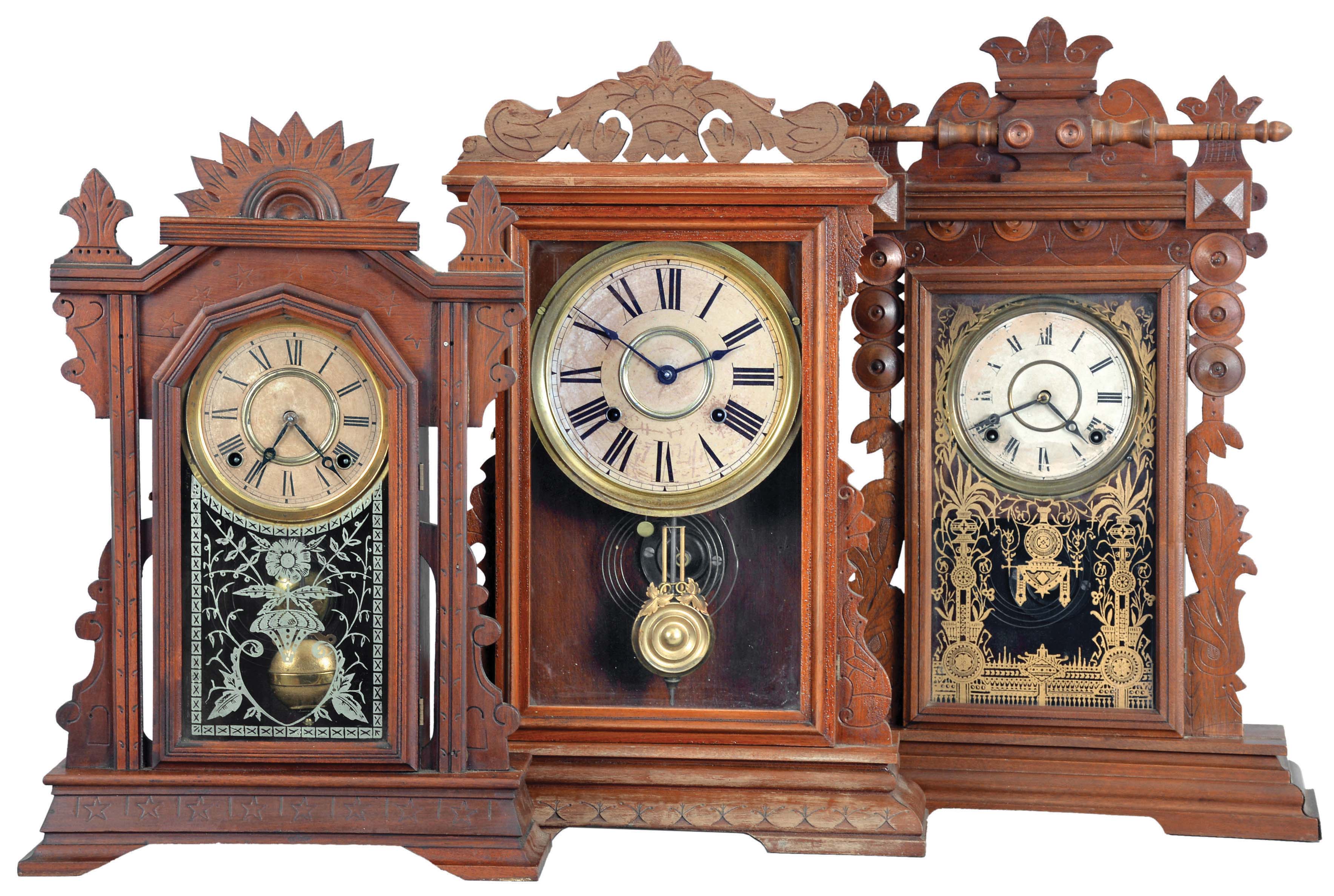 Clocks- 3 (Three): (1) E. Ingraham & Co.,Bristol, Conn., "Cartoon" shelf clock with a spring driven, 8 day, time and strike movement in a walnut case, c1889; (2) E. Ingraham & Co., Bristol, Conn., "Farren" premium model made for Farren Brothers shelf clock with a spring driven, 8 day, time and strike movement in a walnut case, c1880. (3) E. Ingraham & Co., Bristol, Conn., "Ingot" shelf clock with a spring driven, 8 day, time and strike movement in a walnut case, c1896. — Antique Clocks Price Guide