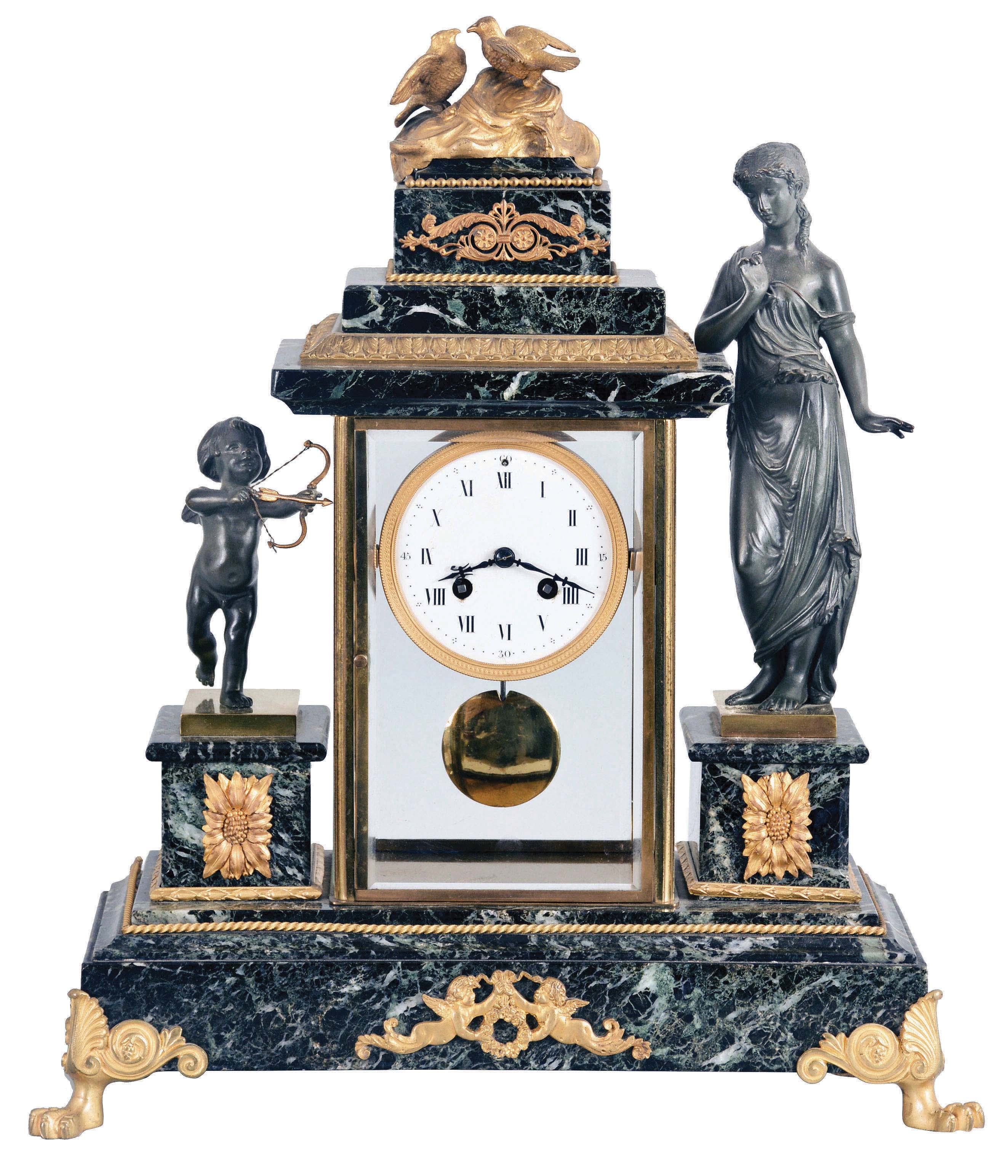Marti Marble and Ormolu Figural Mantel Clock, Paris, with variegated marble, brass and beveled glass case, porcelain roman numeral dial, and marble plinths for Cupid and probably Aphrodite, the Greek goddess of love flanking a stepped top with ormolu trim and doves in a love nest at the top, all on a raised base with Putti on the facade and gargoyle feet, eight-day round French movement cast Marti emblem on the back plate, count-wheel hour and half hour strike on a bell and brass bob pendulum. — Antique Clocks Price Guide
