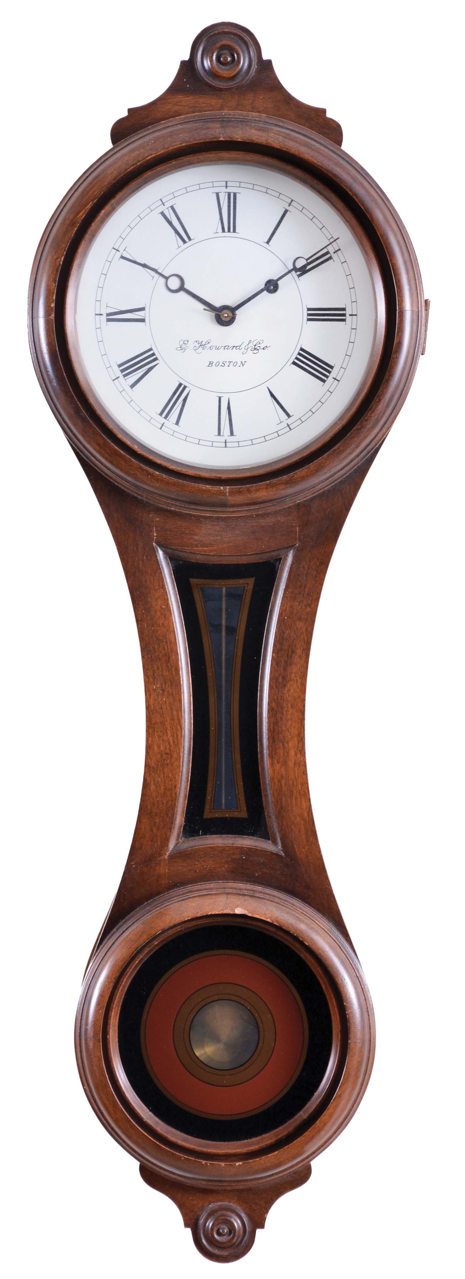 E. Howard & Co.. Boston, Mass., "Regulator No. 10" figure eight reissue wall clock, Serial #211, the walnut case in the figure eight form with roman numeral metal dial signed "E. Howard & Co./Boston", the full length door with glazed opening for the dial, waist section with gold and black geometric shaped decoration and lower 6-inch opening with black, gold and maroon concentric circles and center for pendulum viewing, lower turned drop at the base, eight day brass time only movement with front plate stamped "E. Howard & Co./Boston", "No. 10", "SN 211" and "6/76", recoil escapement all powered by an iron weight and regulated by a brass rod, and brass-faced pendulum bob. — Antique Clocks Price Guide
