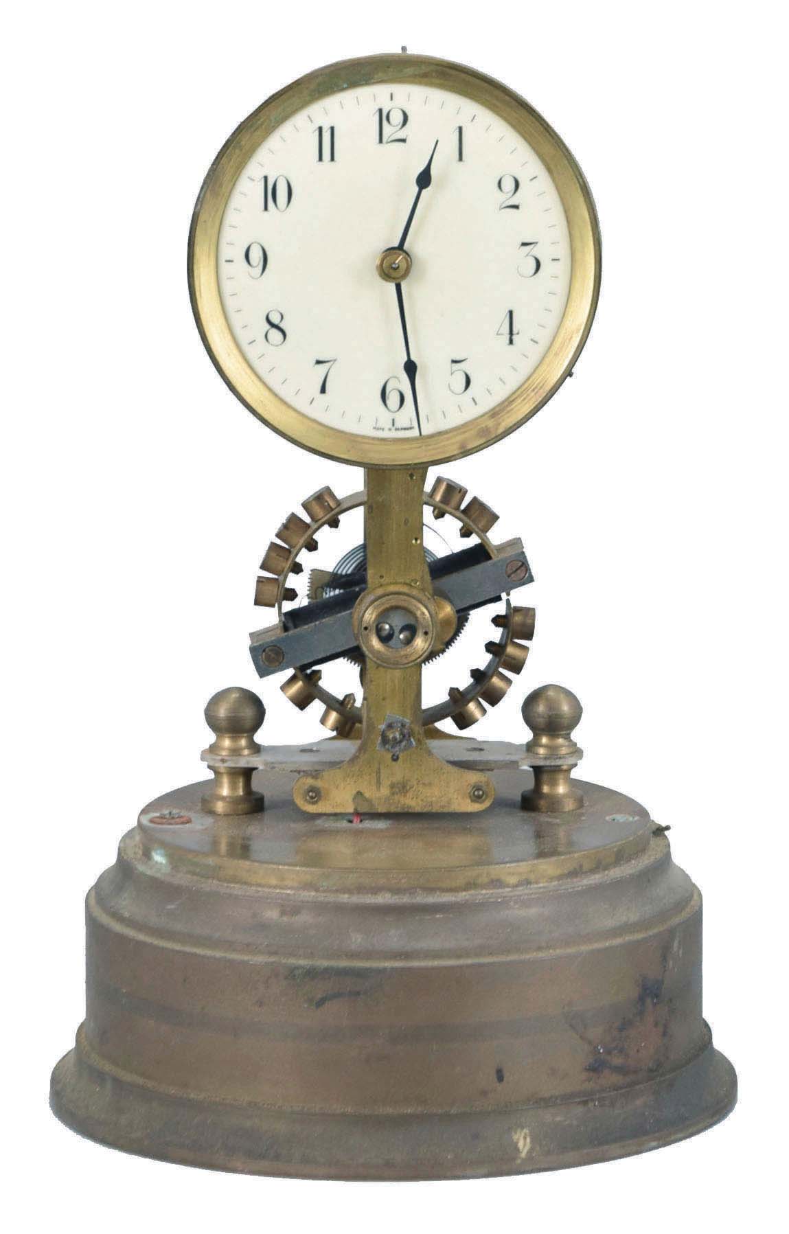 Germany, Eureka style, battery powered, electro-magnetic timepiece mounted on brass base with a large exposed rotating balance. — Antique Clocks Price Guide