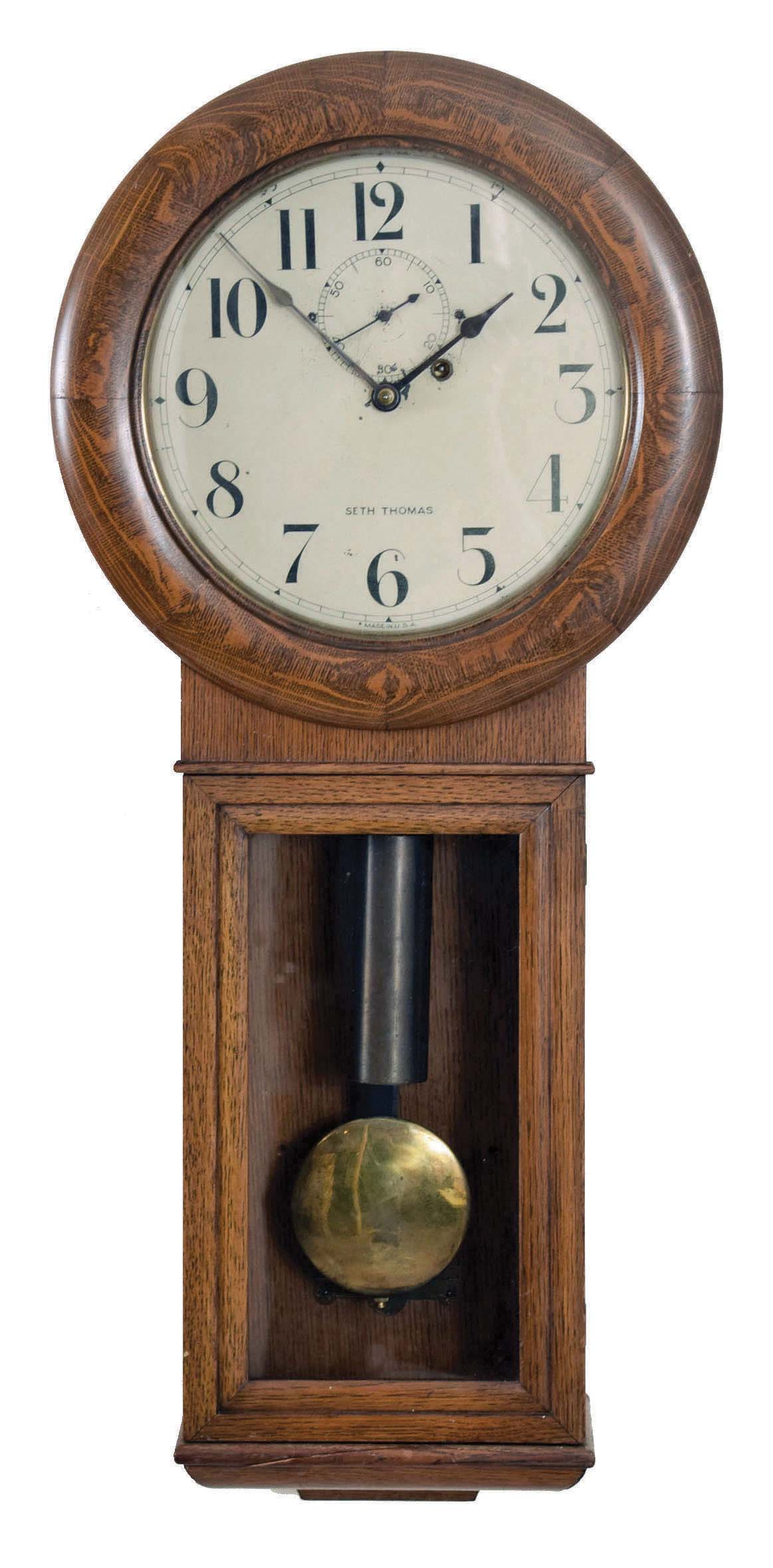 Seth Thomas Clock Co., Thomaston, Conn., "Regulator No. 2" wall hanging clock with a weight driven, 8 day timepiece movement (77A, maintaining power) in an oak case. — Antique Clocks Price Guide