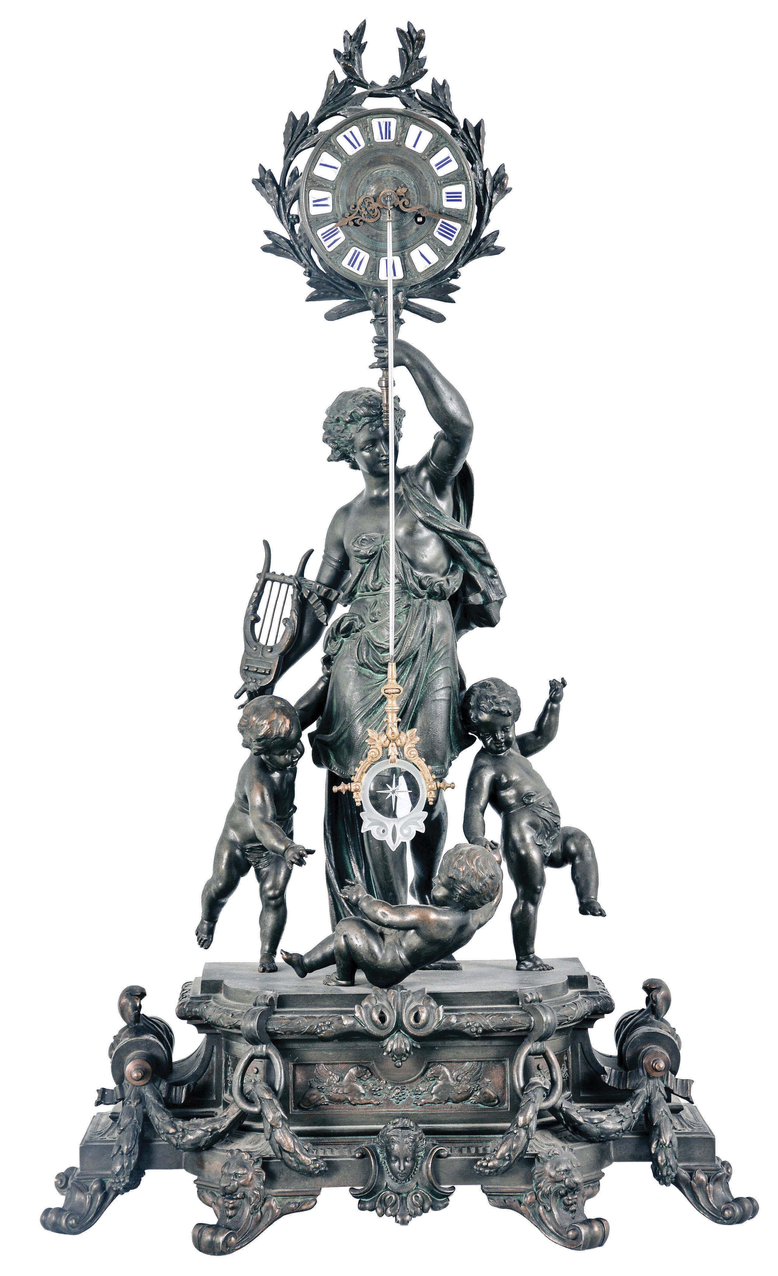 Regnault Fils, Chesnier & Sarrazin, Paris, a large figural mantel clock with front mounted pendulum, the bronzed spelter case with break front base on scroll feet, draped with foliate garlands, and further ornamented with masks, front with relief panel featuring recumbent, addorsed gryphons, and laurel molded, conforming plinth supporting a young male figure, the clock case surrounded by laurel fronds and held aloft in his left hand, a lyre in his right, with three disporting putti at his feet, patinated dial with applied, Roman numeral cartouches, pierced and engraved gilt hands, and with ornamental pendulum oscillating in front of the dial, signed, 8 day, time and strike pendule de Paris movement with Brocot escapement behind the back plate — Antique Clocks Price Guide