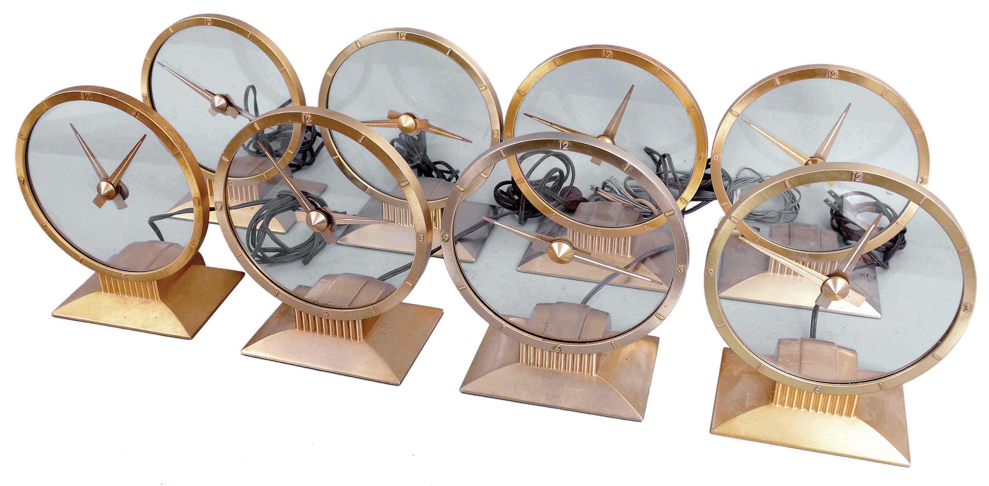 Clocks- 8 (Eight) Jefferson Electric Company, Bellwood, Illinois, "Golden Hour" electric mystery clock with hands suspended in clear glass dial in gold plated cases with classic mid-century modern design. — Antique Clocks Price Guide