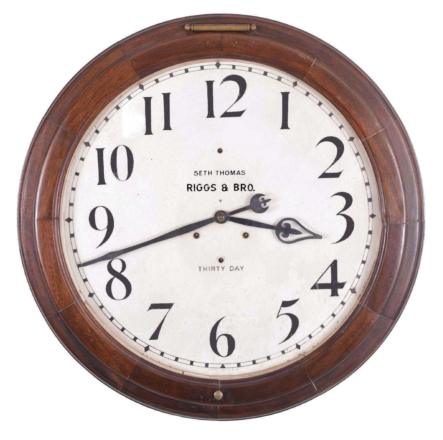 Seth Thomas Clock Co., Thomaston, Conn., "Arcade 24 Inch" wall timepiece, fitted with a large double spring thirty day movement, mahogany finish on mixed hardwood case, and with 24 inch dial, retailed by Riggs & Bro, Philadelphia, and with the name RIGGS & BRO. on dial. — Antique Clocks Price Guide