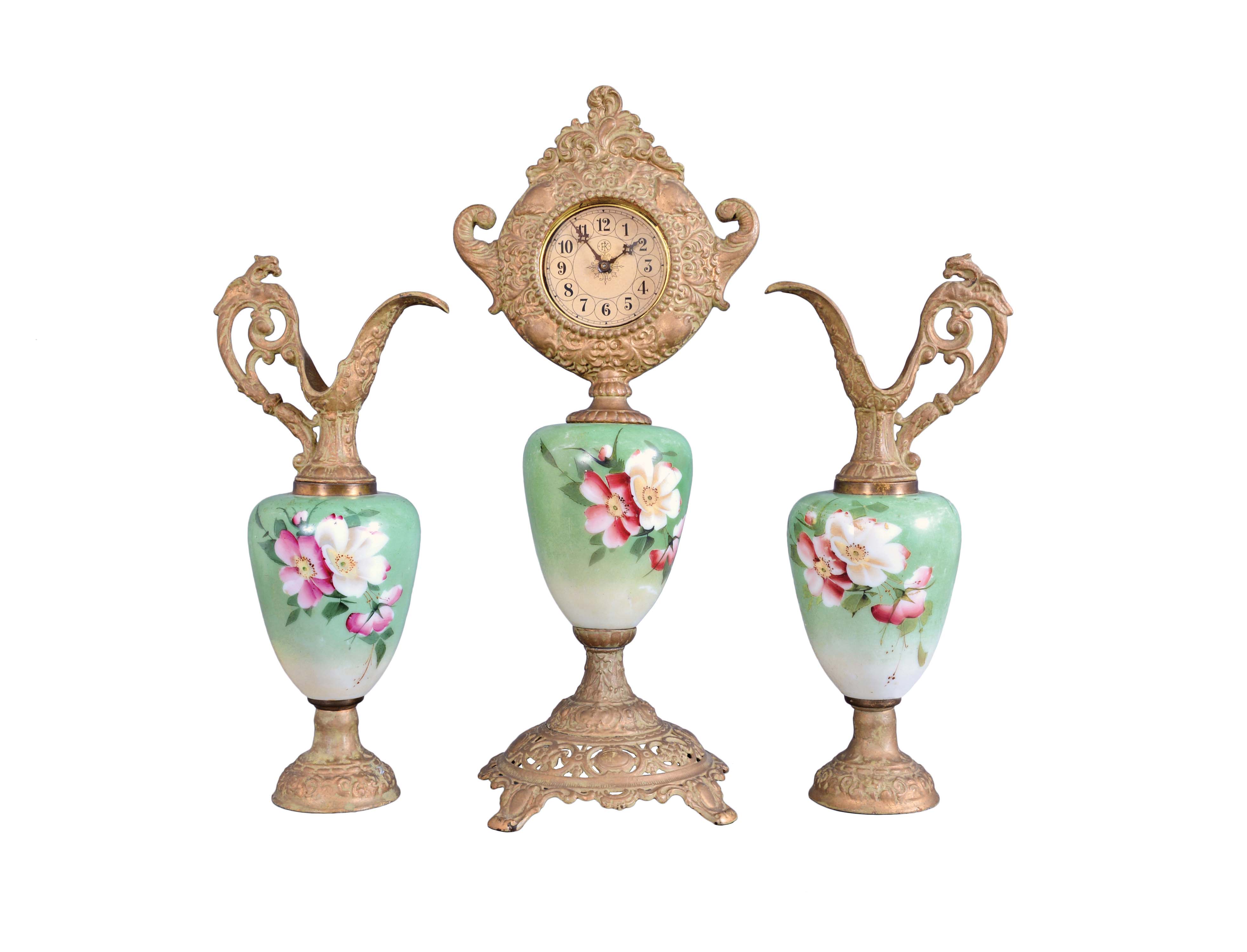 F. Kroeber Clock Co., New York, "China K457" 3 piece mantel garniture, clock and matching ewers, 30 hour, time only, spring driven lever escapement mounted on green porcelain with floral motif supported and topped by cast spelter parts with finish simulating old bronze with verdigris. — Antique Clocks Price Guide