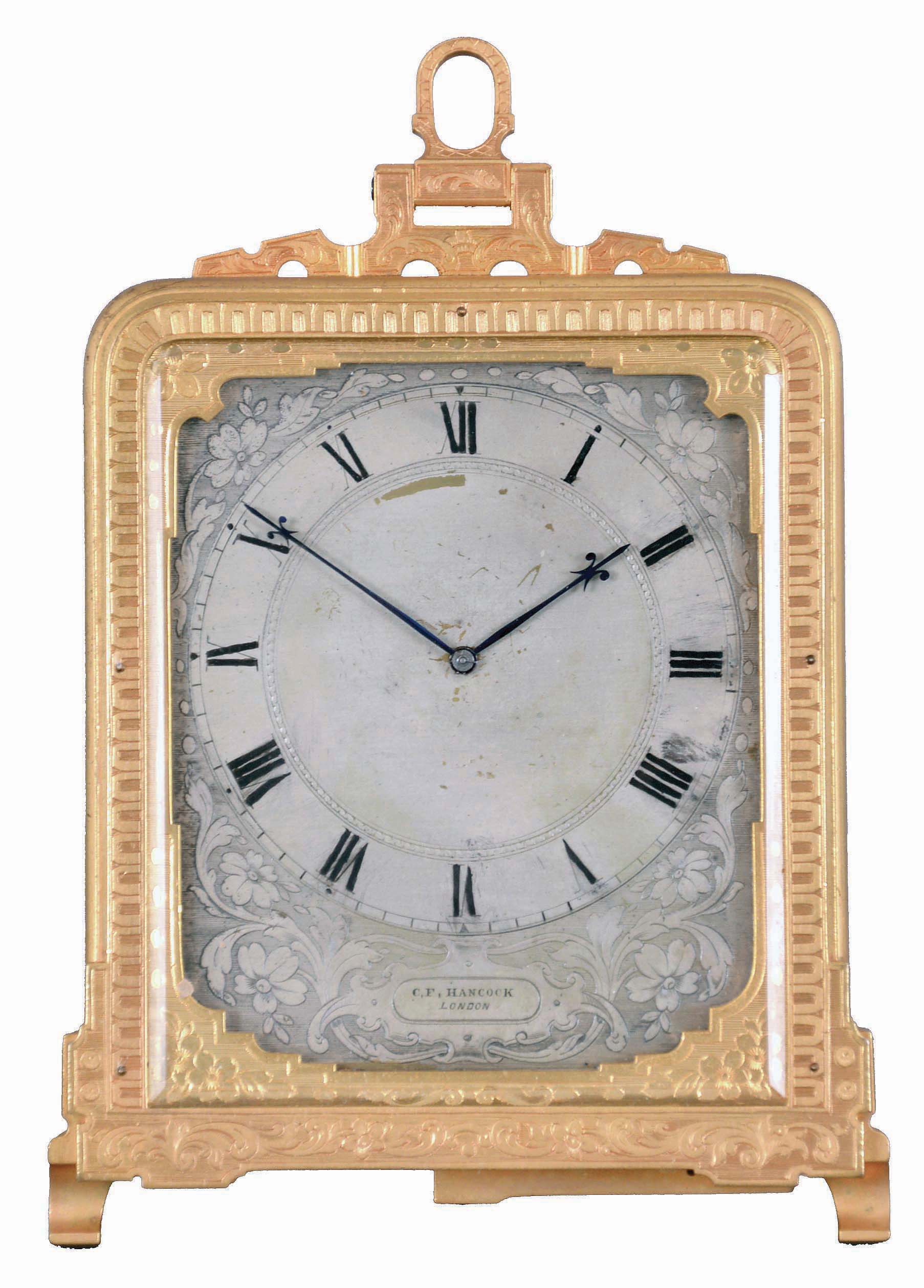 Thomas Cole, for C.F. Hancock, London, a decorative strut timepiece, the gilt case with fine engraved ornament, Roman numeral engraved and silvered dial with retailers signature below 6:00, the dial with fretted and engraved gilt mask and blued steel fleur de lis hands, 8 day timepiece movement with lever escapement and polished steel balance, signed "Thomas Cole London", serial #1644 — Antique Clocks Price Guide