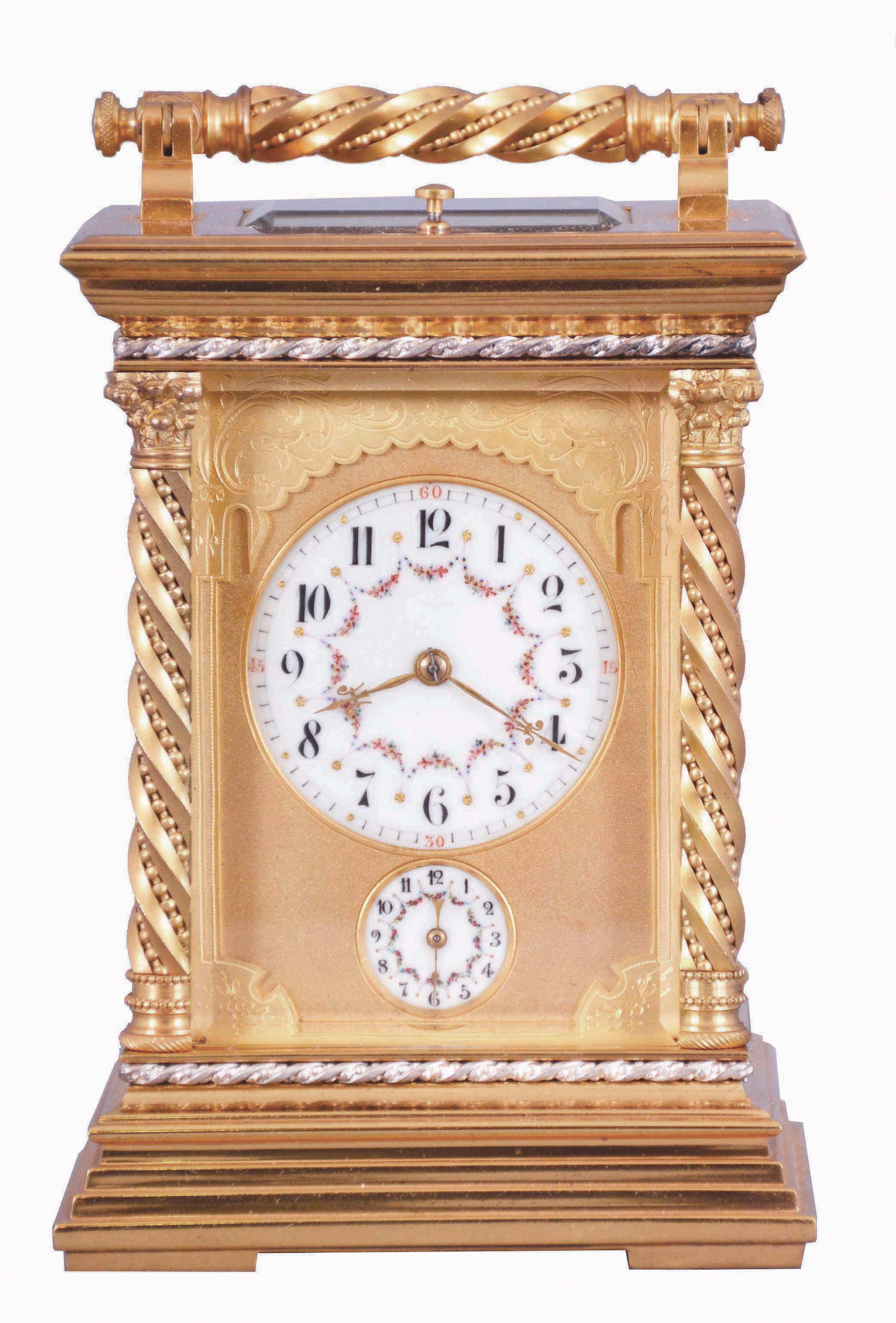 France, a large and unusual hour repeating carriage clock, the glazed, gilt case with stepped base, corners with twisted, beaded columns, the top with carrying handle of the same design as the columns, smaller twist and bead silvered bands above base and below cornice, Arabic numeral white enamel dials decorated with floral garlands and with double gilt mask, the outer portion fretted and engraved, the inner matted, gold fleur de lis hands, 8 day time, strike, and alarm movement with lever platform and cut bimetallic balance, serial #133 — Antique Clocks Price Guide