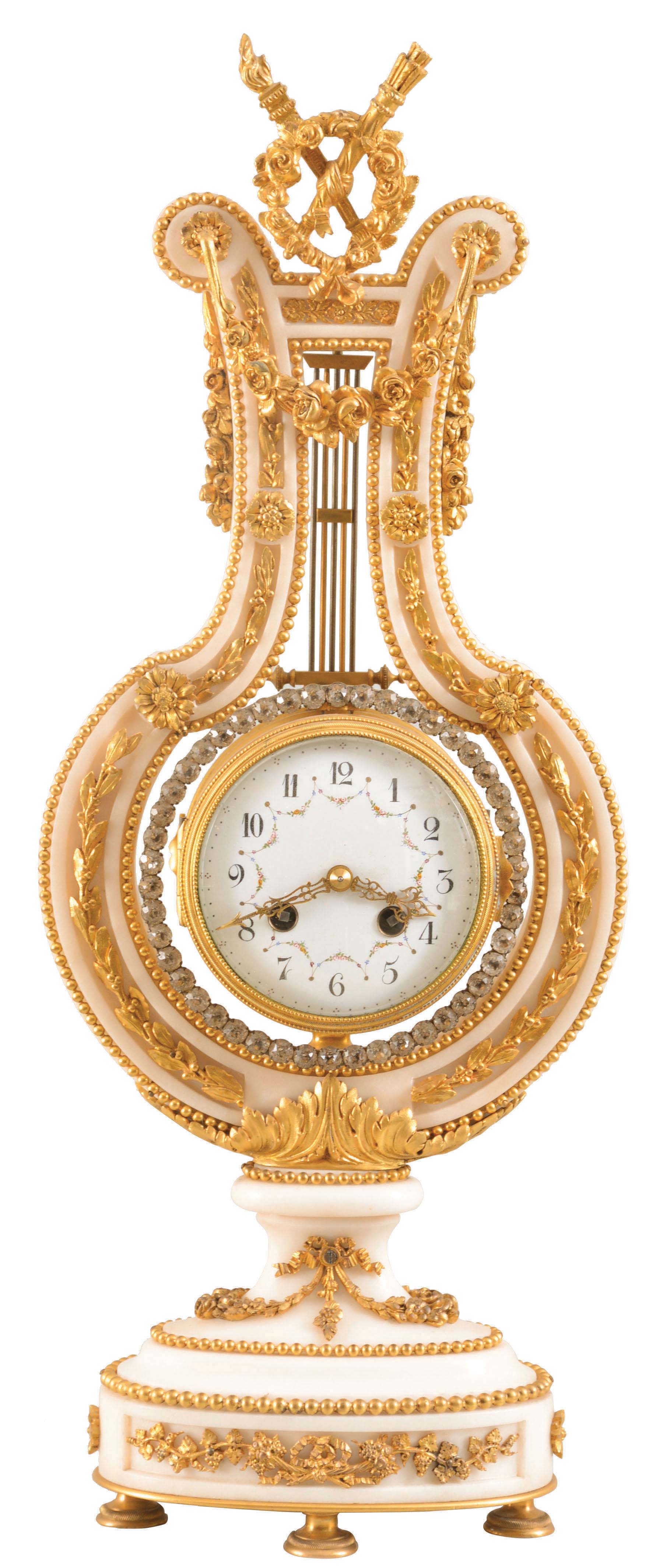 France, for Harris & Harrington, New York, lyre form mantel clock, white marble case with gilt bronze mounts, including fruit and floral festoons, trailing vines and other foliate ornament, the top with rose wreath, torch and quiver, knife edge pendulum suspended behind the top ornament and with oscillating ring of brilliants, Arabic numeral white enamel dial with polychrome enamel garlands, ornate, gilt, pierced and engraved hands, 8 day, time and strike pendule de Paris movement, c1900 — Antique Clocks Price Guide