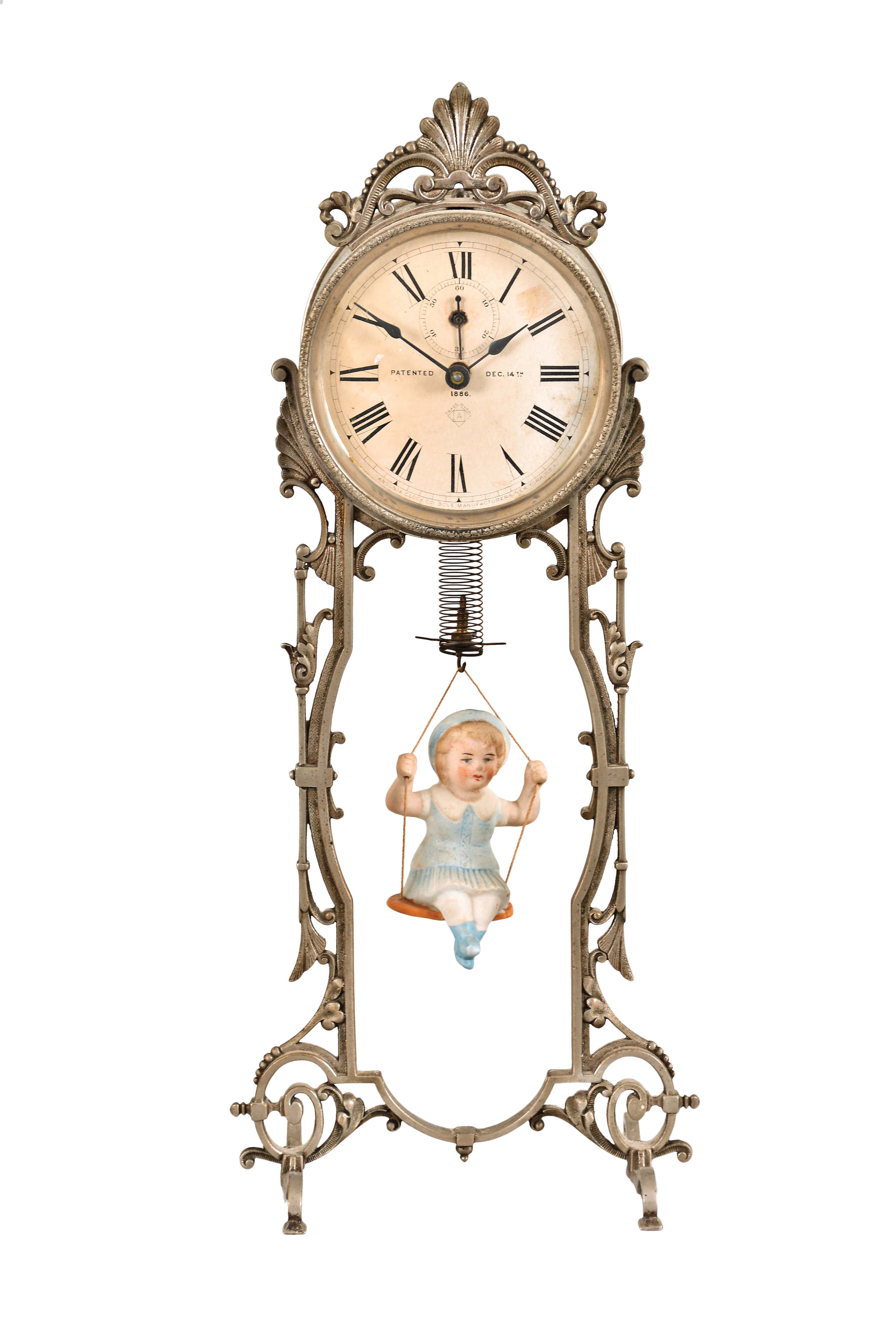 Ansonia Clock Co., New York, "Jumper No. 2" bobbing doll novelty timepiece, 30 hour, time only, spring driven movement that powers the clock and bouncing bisque doll, cast metal stand, 4 inch paper dial. — Antique Clocks Price Guide