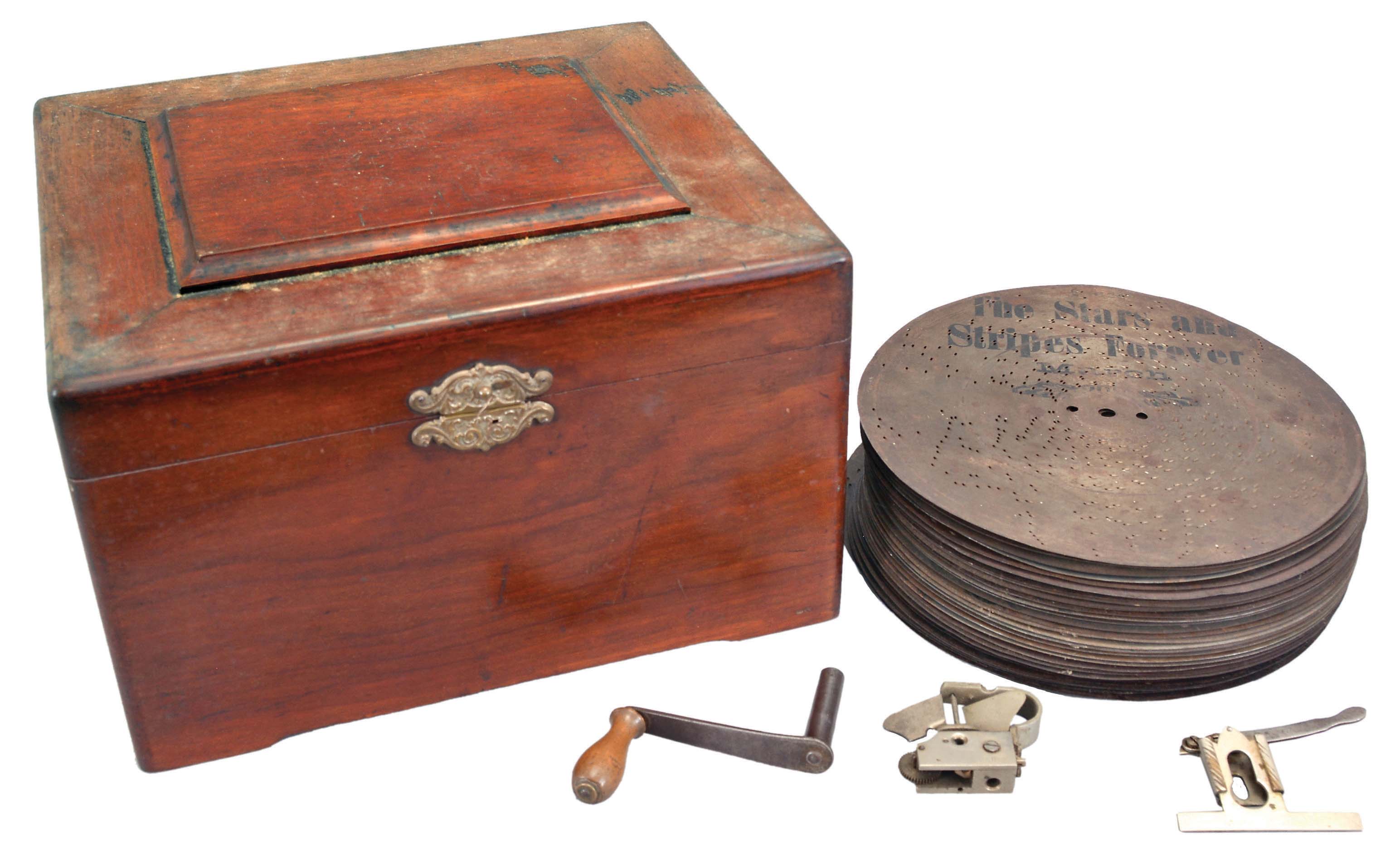 Mira, St. Croix, Switzerland, "Empress" music box playing 9.25 inch discs on a comb with 48 teeth in a mahogany case with an assortment of 32 discs. — Antique Clocks Price Guide